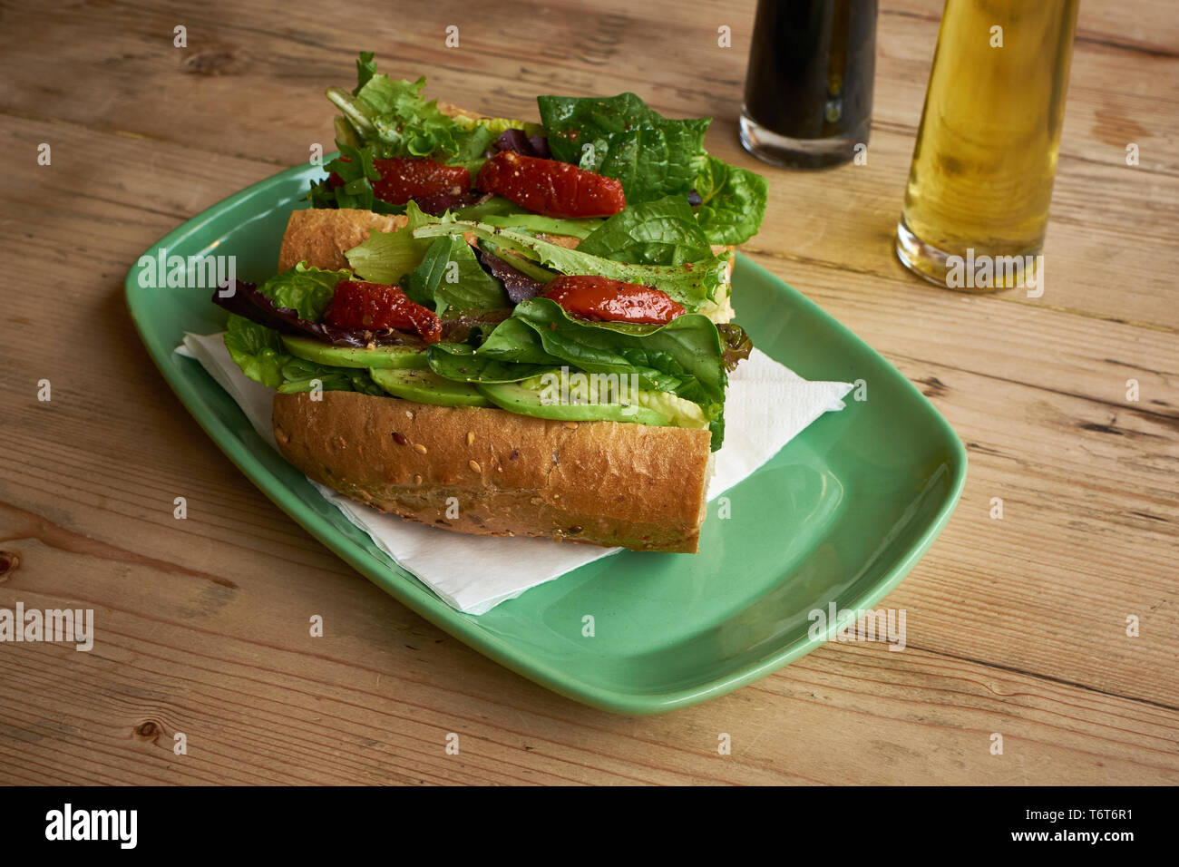 Sundried tomato sandwich on wooden table Stock Photo