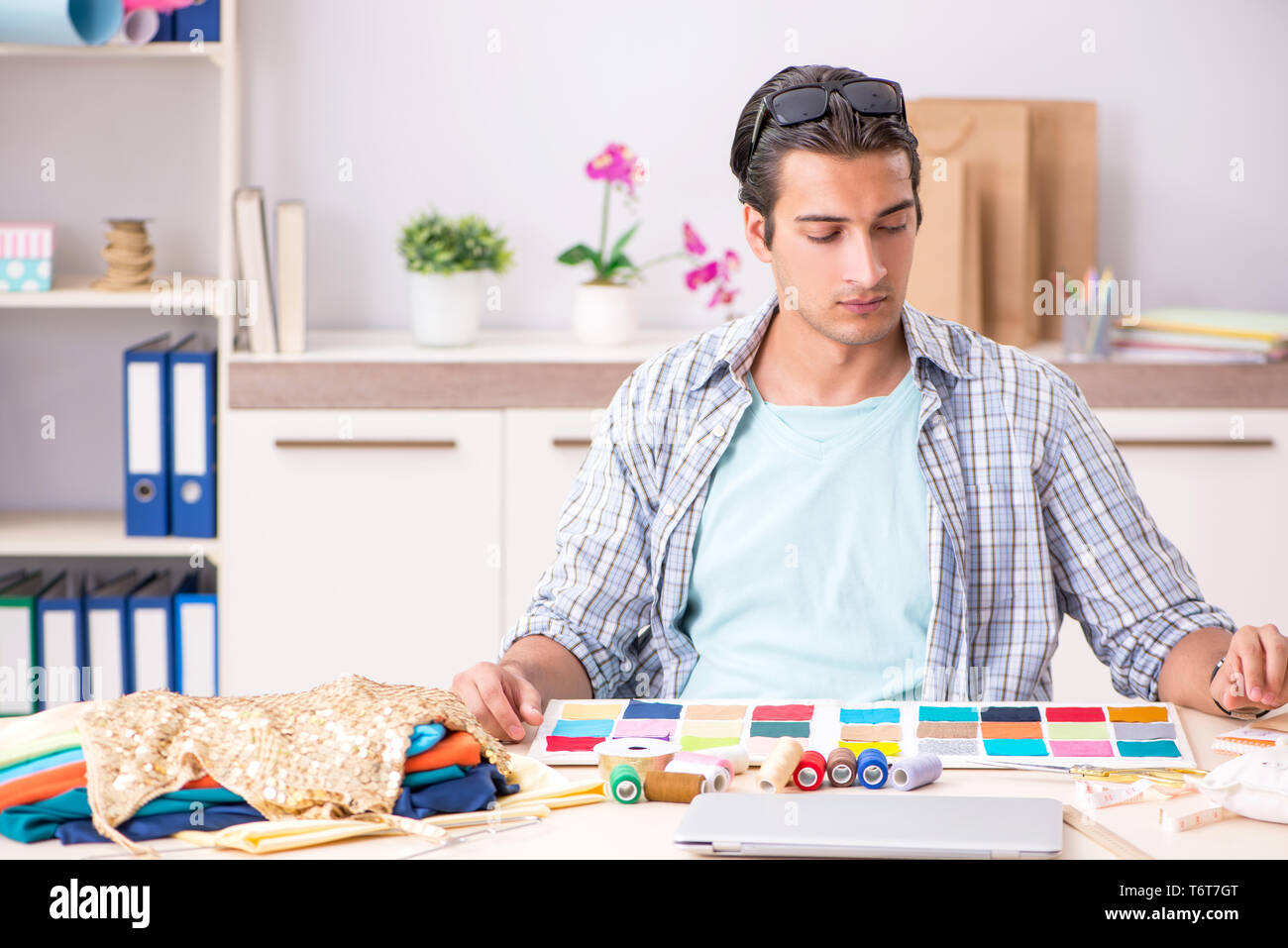 Young handsome tailor working in his workshop Stock Photo - Alamy