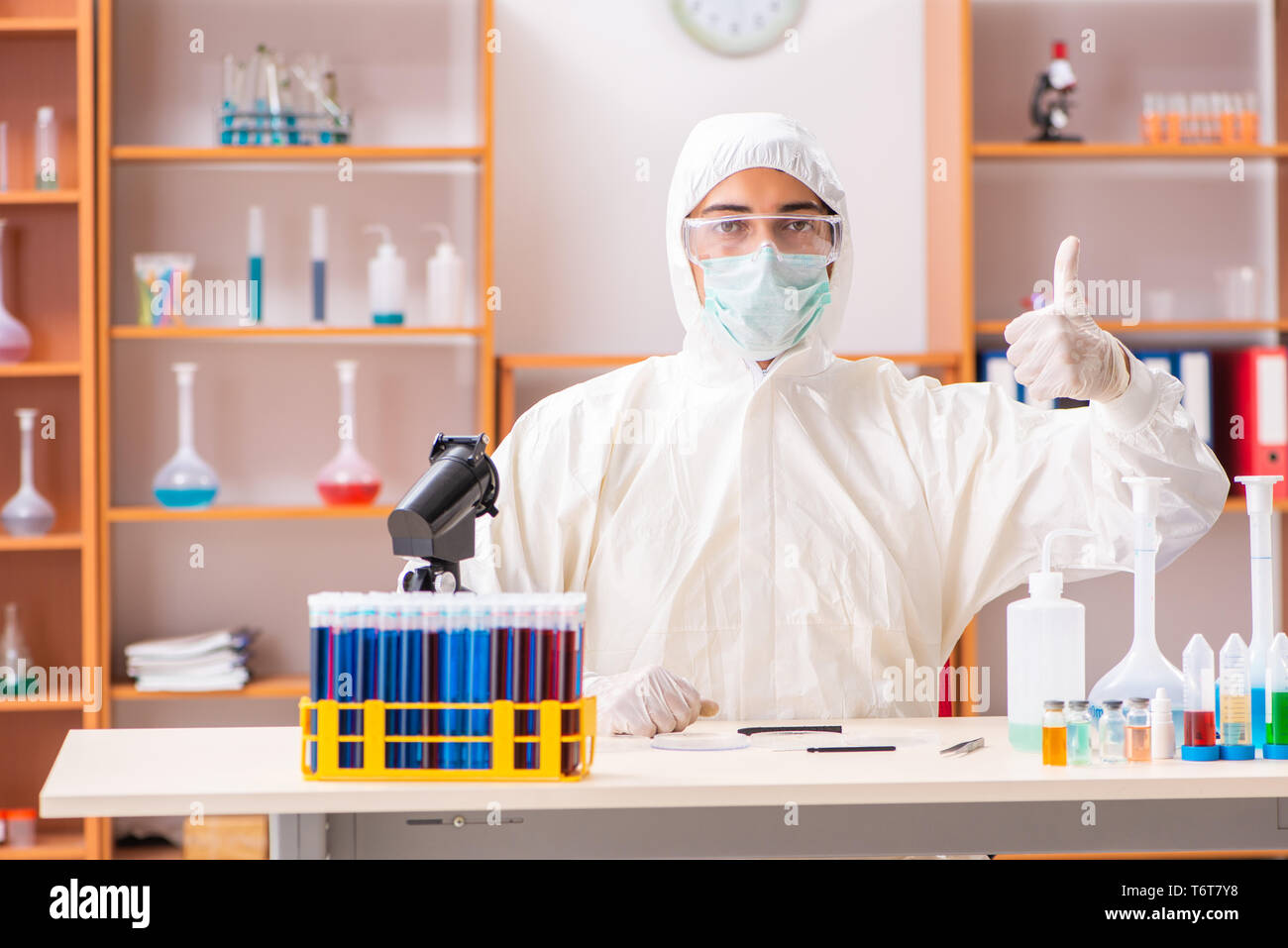 Young biochemist wearing protective suit working in the lab Stock Photo