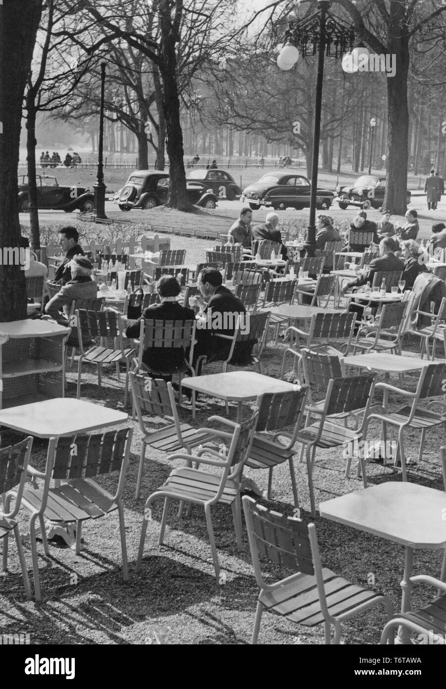1950s open-air cafe. On this spring day people have found the cafe a nice place to enjoy the sunshine while eating and drinking. Sweden 1950s Stock Photo
