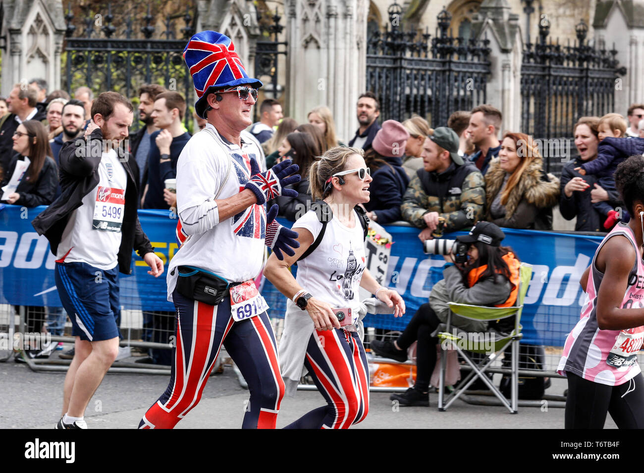 London, England – April 28, 2019: A British couple takes the final mile of the Virgin Money London Marathon. Stock Photo