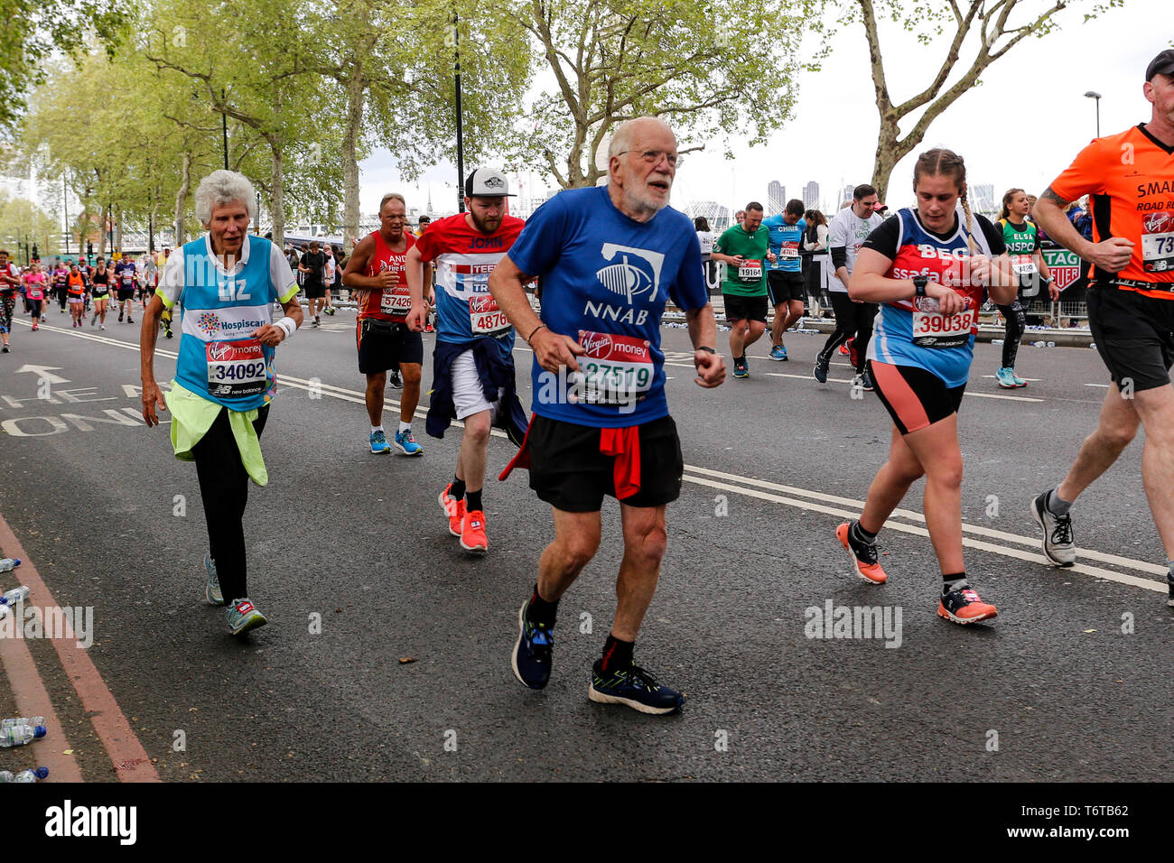 London, England – April 28, 2019: An elderly couple on their final mile of the Virgin Money London Marathon. Stock Photo