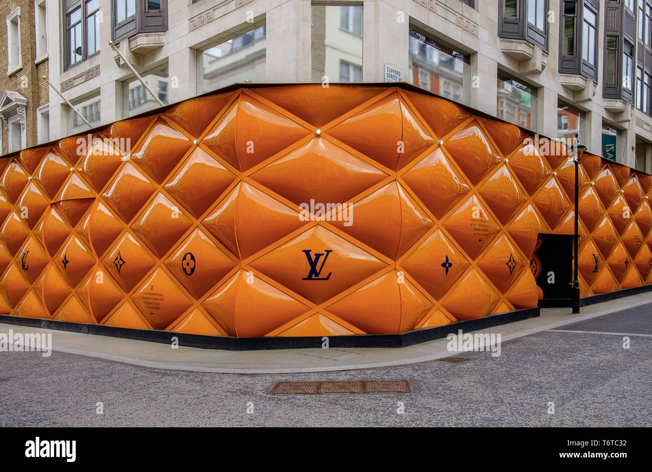 London, UK, March 2019, building site fence panels for a Louis Vuitton shop  in the Mayfair area Stock Photo - Alamy