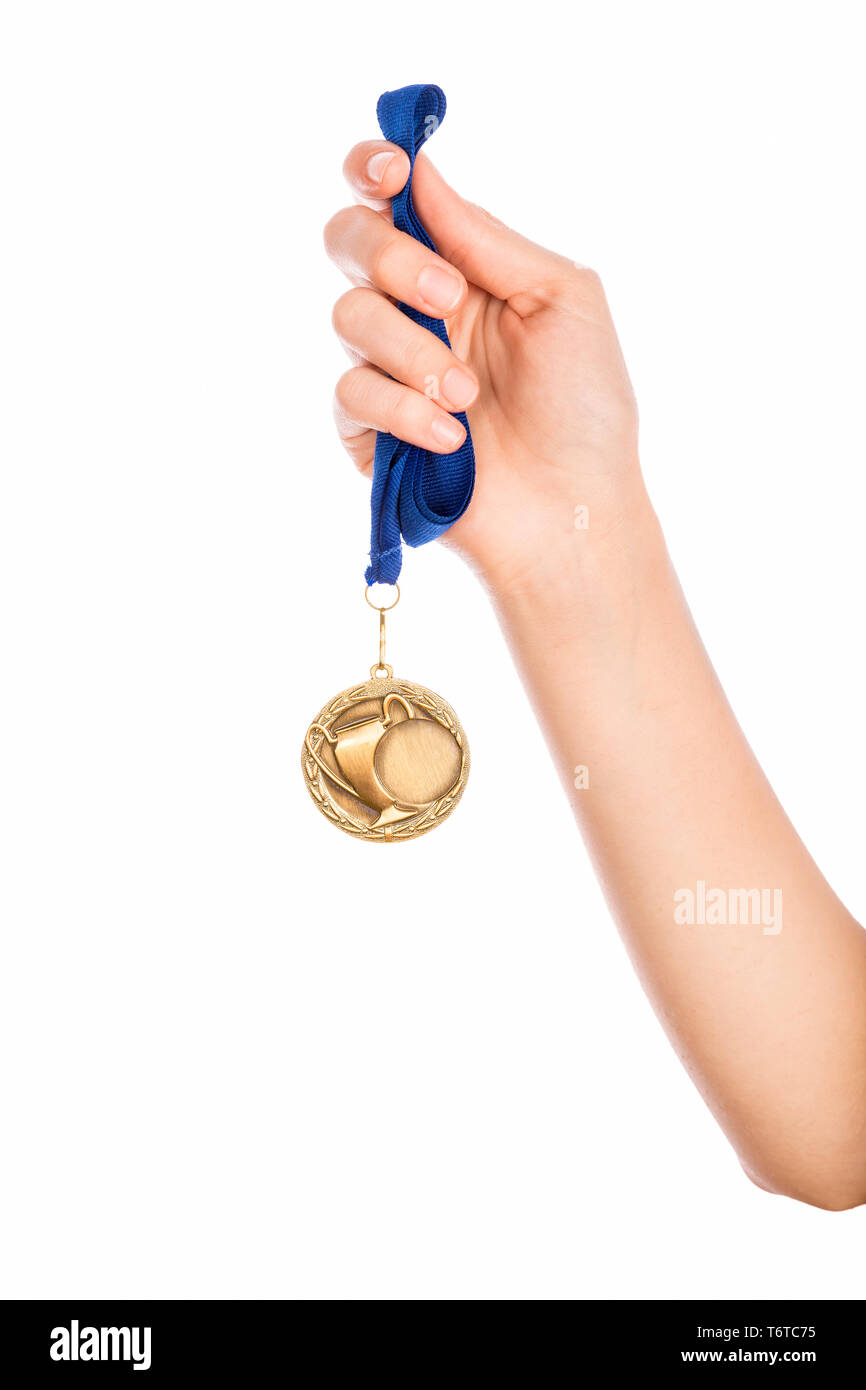 Girl hand raised holding gold medal against white background award and victory concept Stock Photo