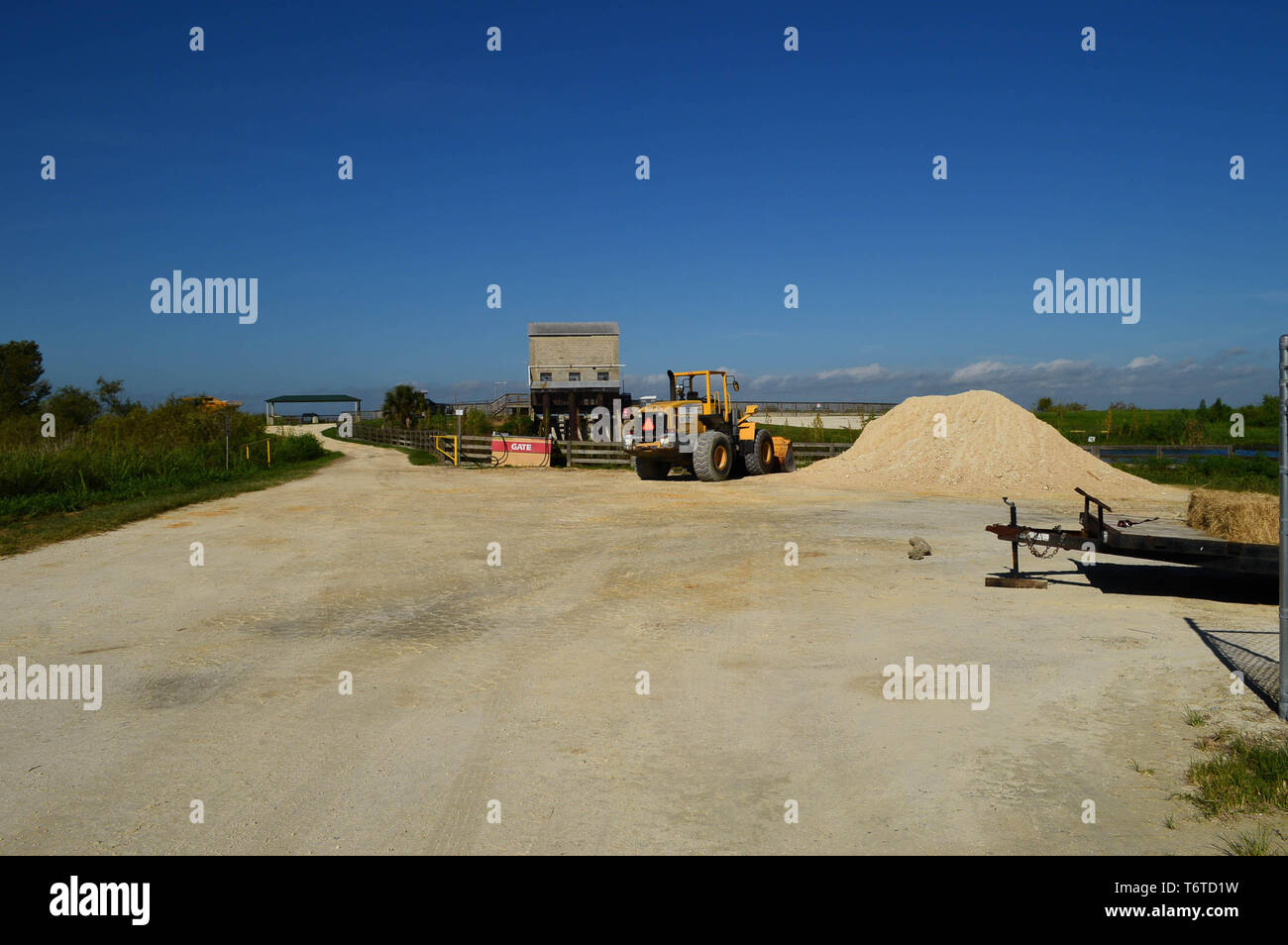 Heavy Machinery Road Construction on Lime Rock Earthen Florida Dirt Road Remote Industrial Area Diesel Fuel Pump Station Commercial Development Photo Stock Photo