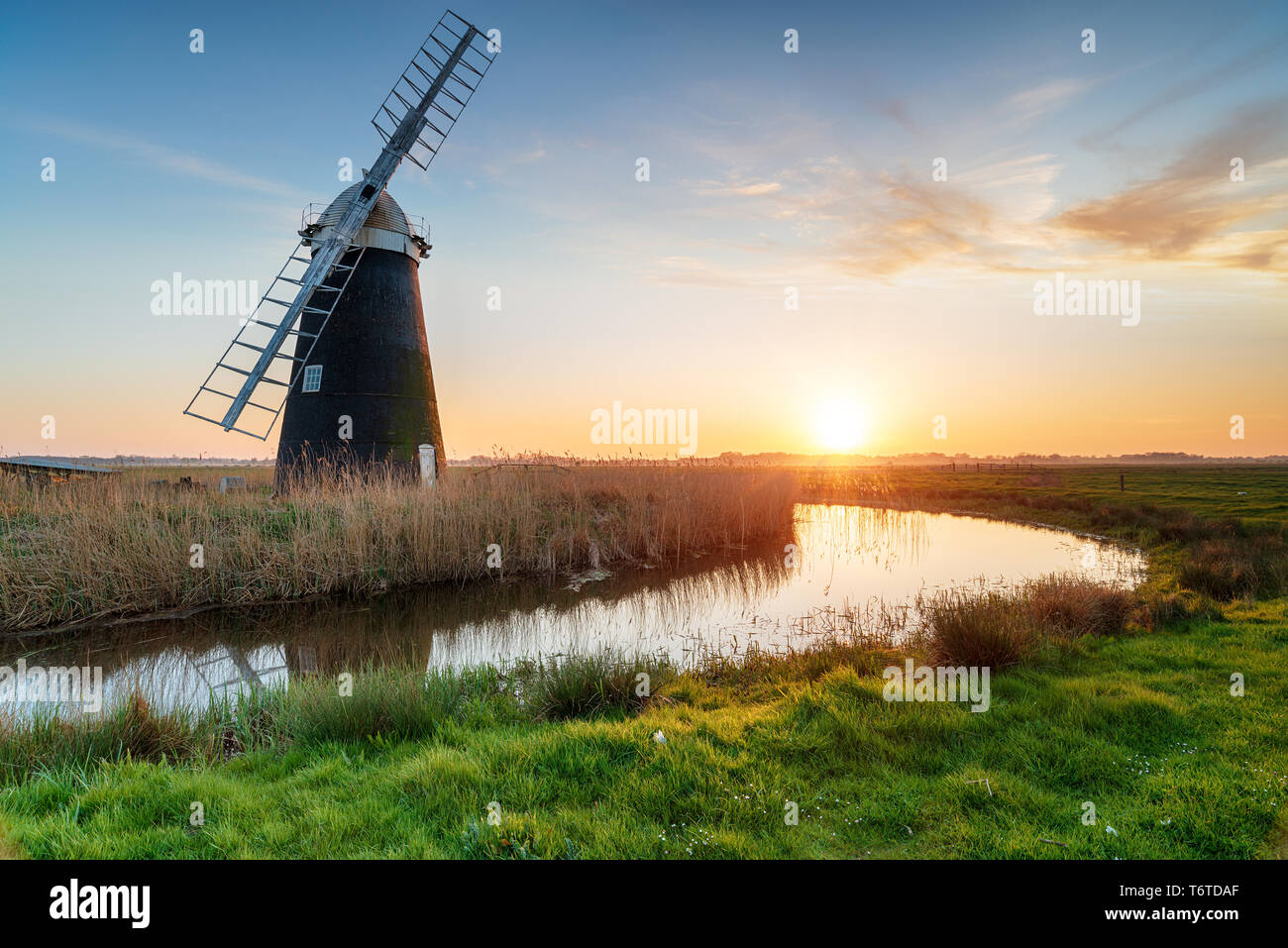 Stunning sunset over Mutton's Drainage Mill on Berney Marshes on the Norfolk Broads, also known as Halvergate Windmill Stock Photo