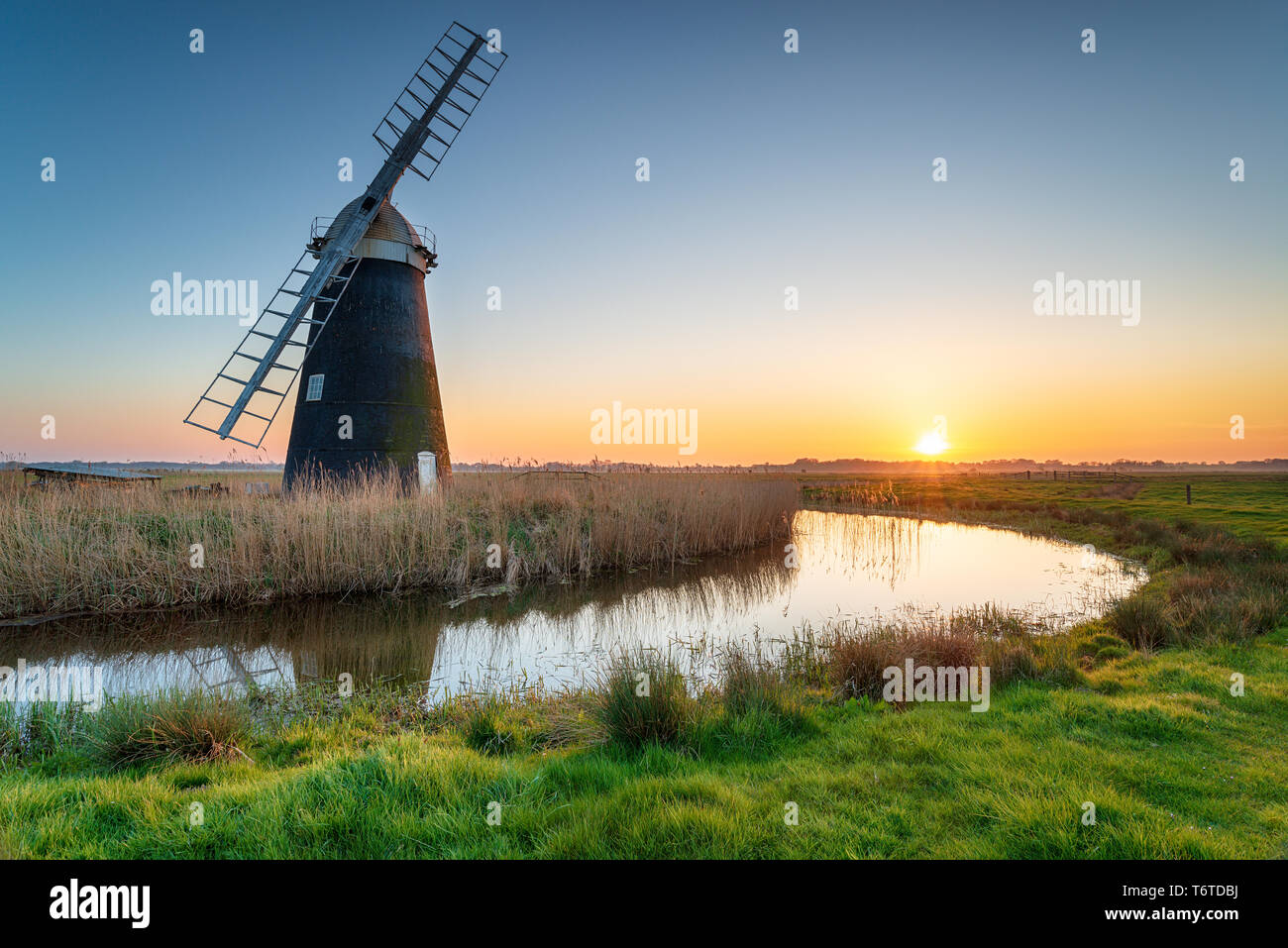 Stunning sunset over Mutton's Drainage Mill at Halvergate on the Berney Marshes on the Norfolk Broads Stock Photo