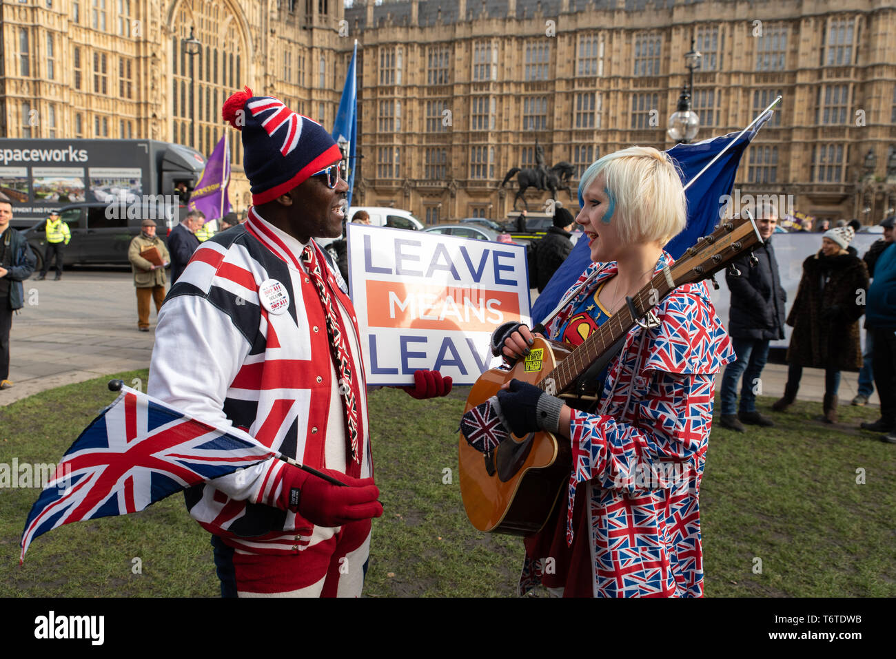 Joseph Afrane, 55, security agent and pro-Brexit, talks with Madeleina Kay, political activist, artist and Remainer, Westminster, London. Jan. 2019 Stock Photo