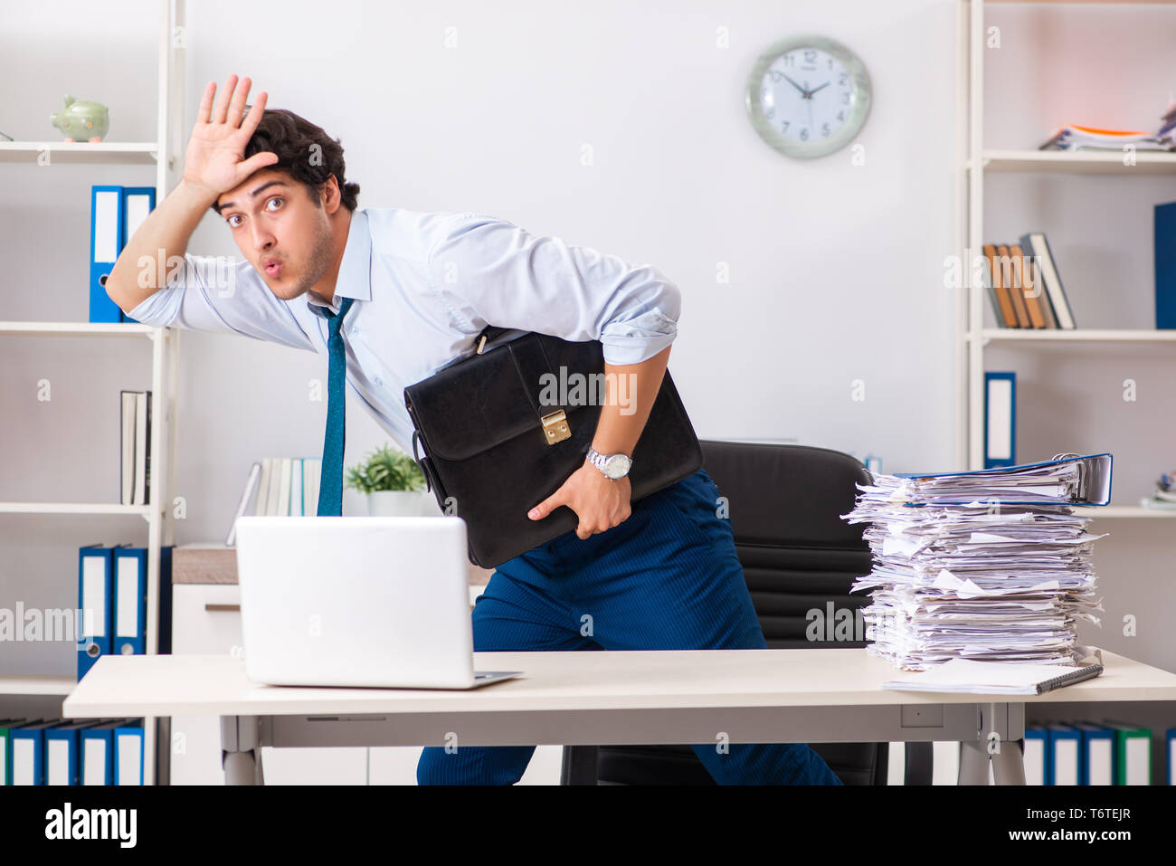 Overloaded busy employee with too much work and paperwork Stock Photo ...