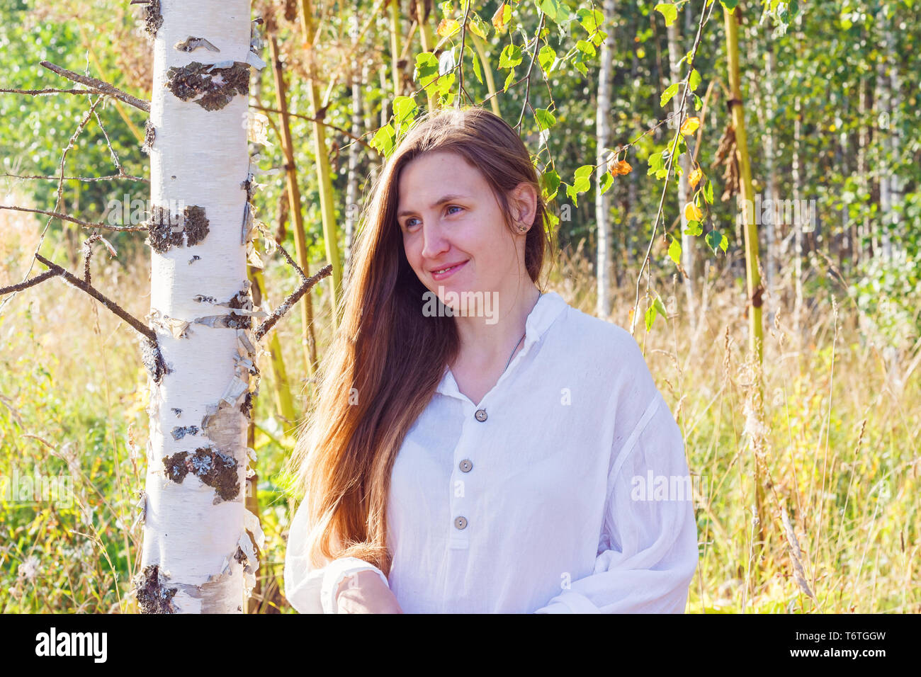 Girl near birch in the forest Stock Photo - Alamy