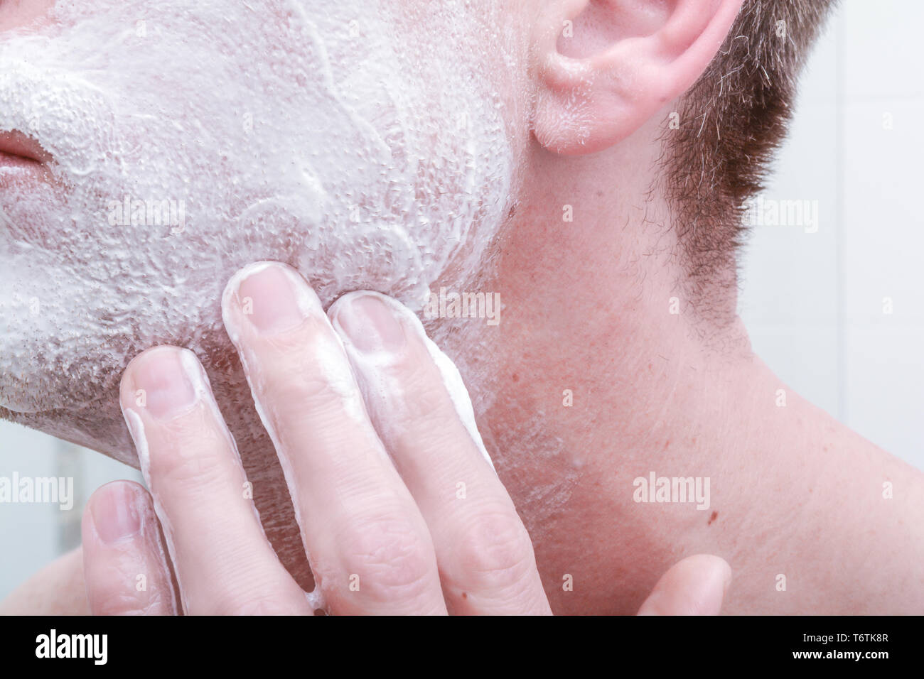 Applying shaving foam to face before shaving in the bathroom Stock Photo Alamy