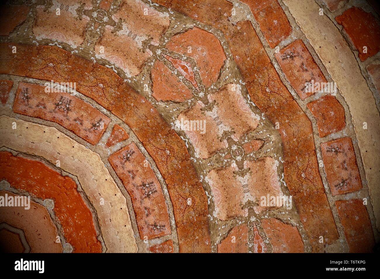 Abstract image created with a kaleidoscope filter. Orange brown brickwork. Stock Photo