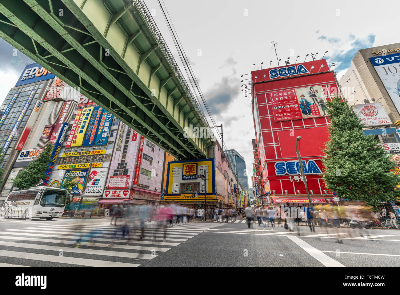 Colorful Bilboard Advertisements Motion Blurred crowd at Chuo Dori Street and Sobu-sen Line crossing at Akihabara Electric Town, Tokyo, Japan Stock Photo