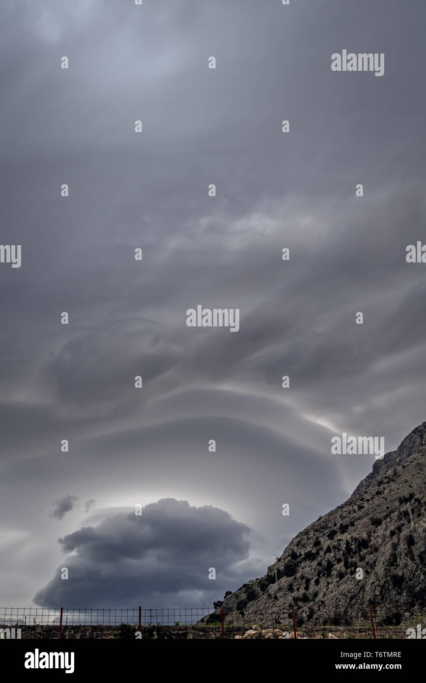 Strange clouds on the stormy sky Stock Photo