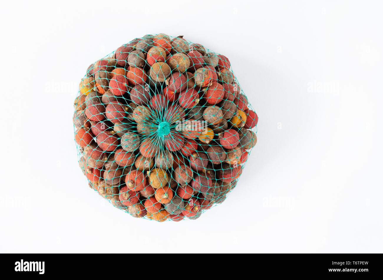 Corosso Corozo fruit in a mesh on white background. Space to copy Stock Photo ...