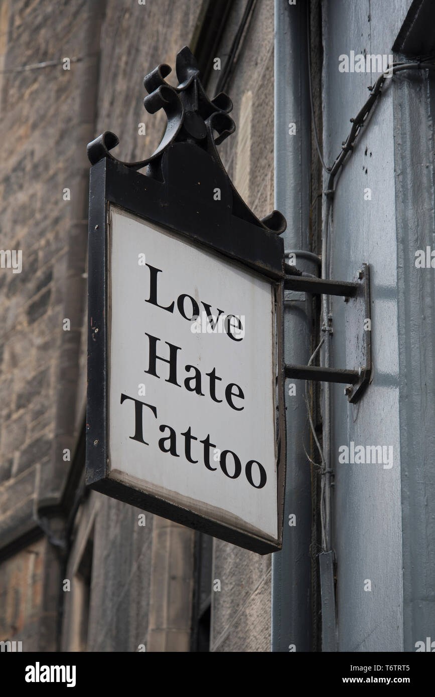 Love Hate Tattoo sign outside a tattoo parlour in Edinburgh, Scotland, UK. Stock Photo