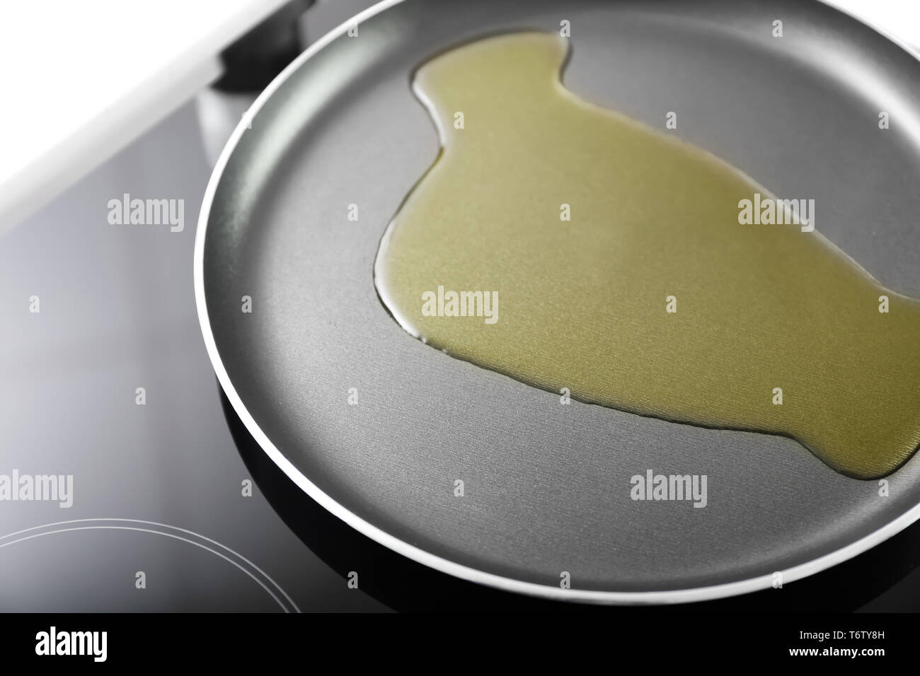 Frying pan with olive oil on stove Stock Photo Alamy