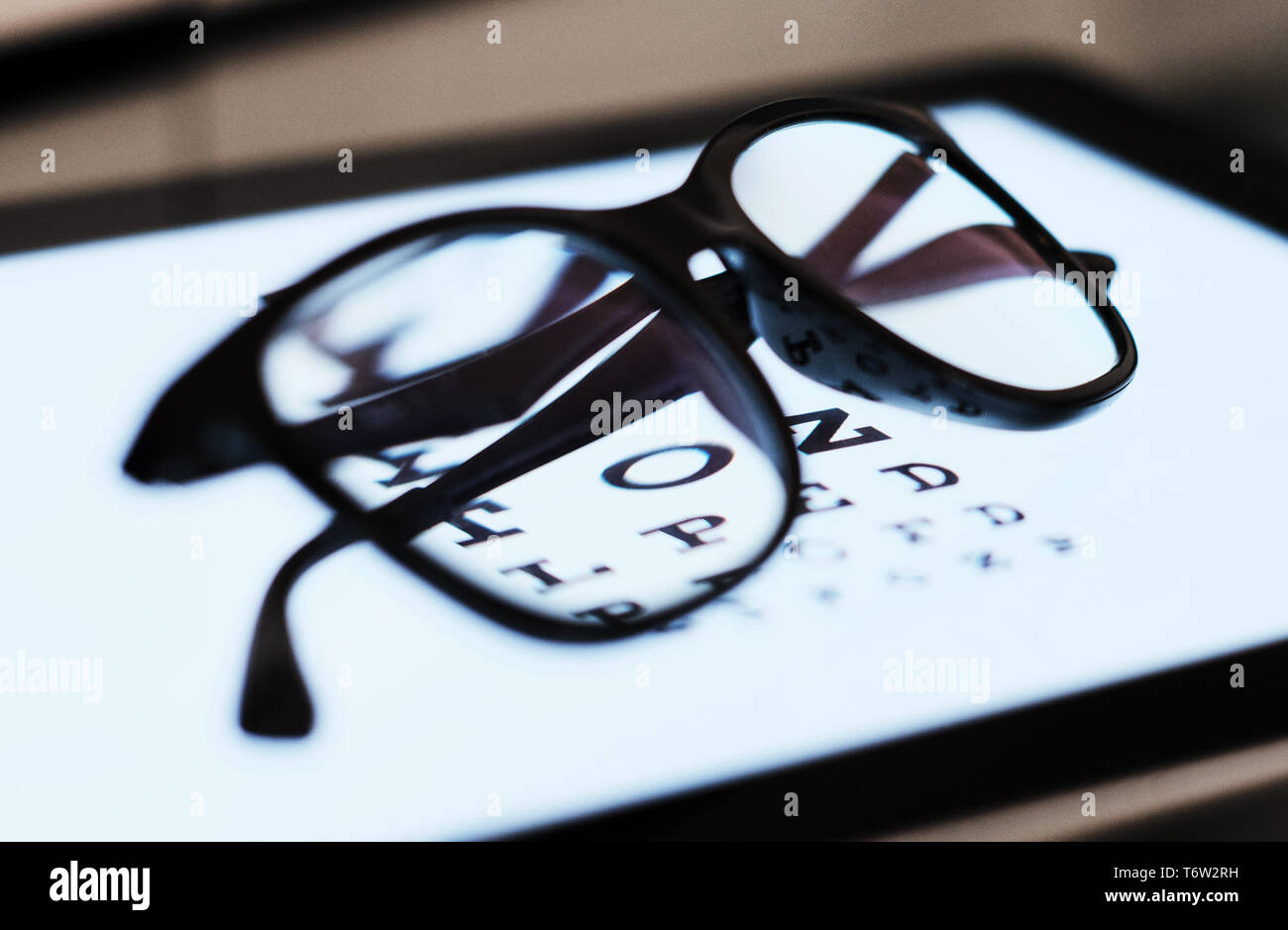 eye chart on tablet and the glass with E Standard Logarithm Eyesight