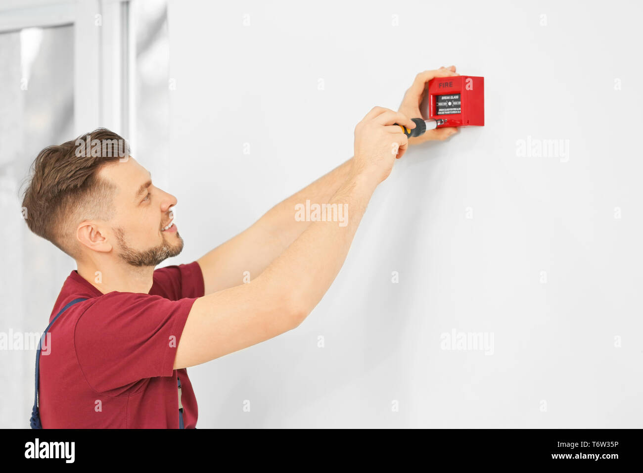 Electrician installing fire alarm system Stock Photo Alamy