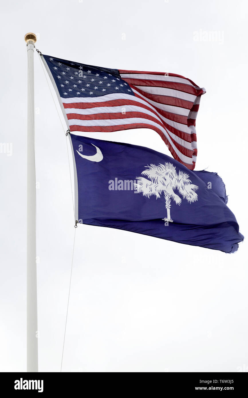 The flags of the United States of America and South Carolina flying on a flagpole. Stock Photo
