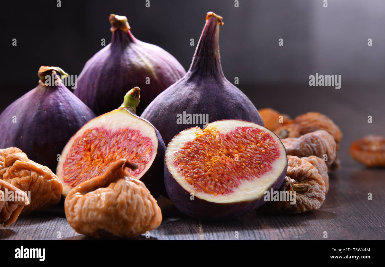 Composition with fresh and dried figs on wooden table. Stock Photo
