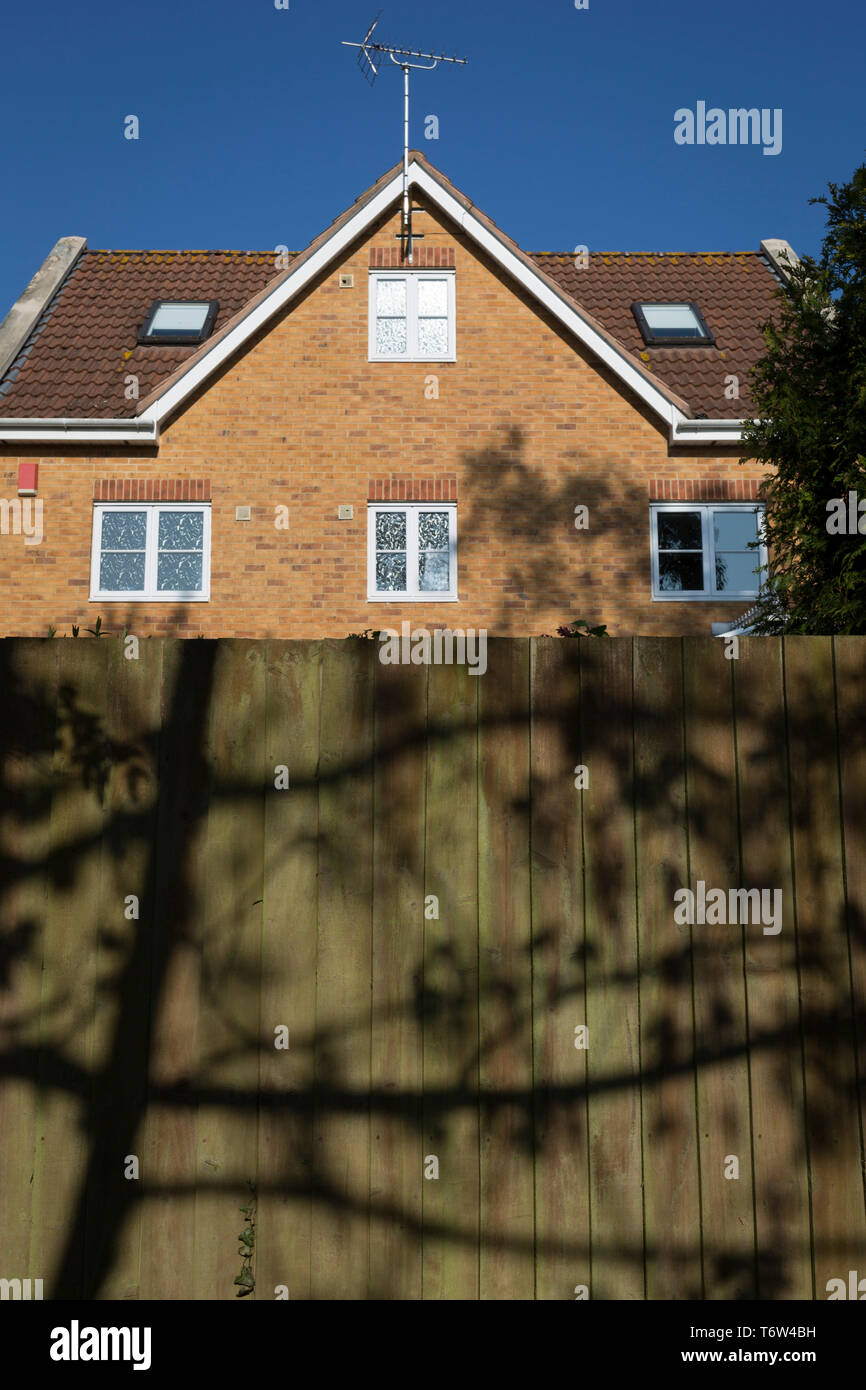 A local house and boundary fence on a middleclass housing estate on 21st