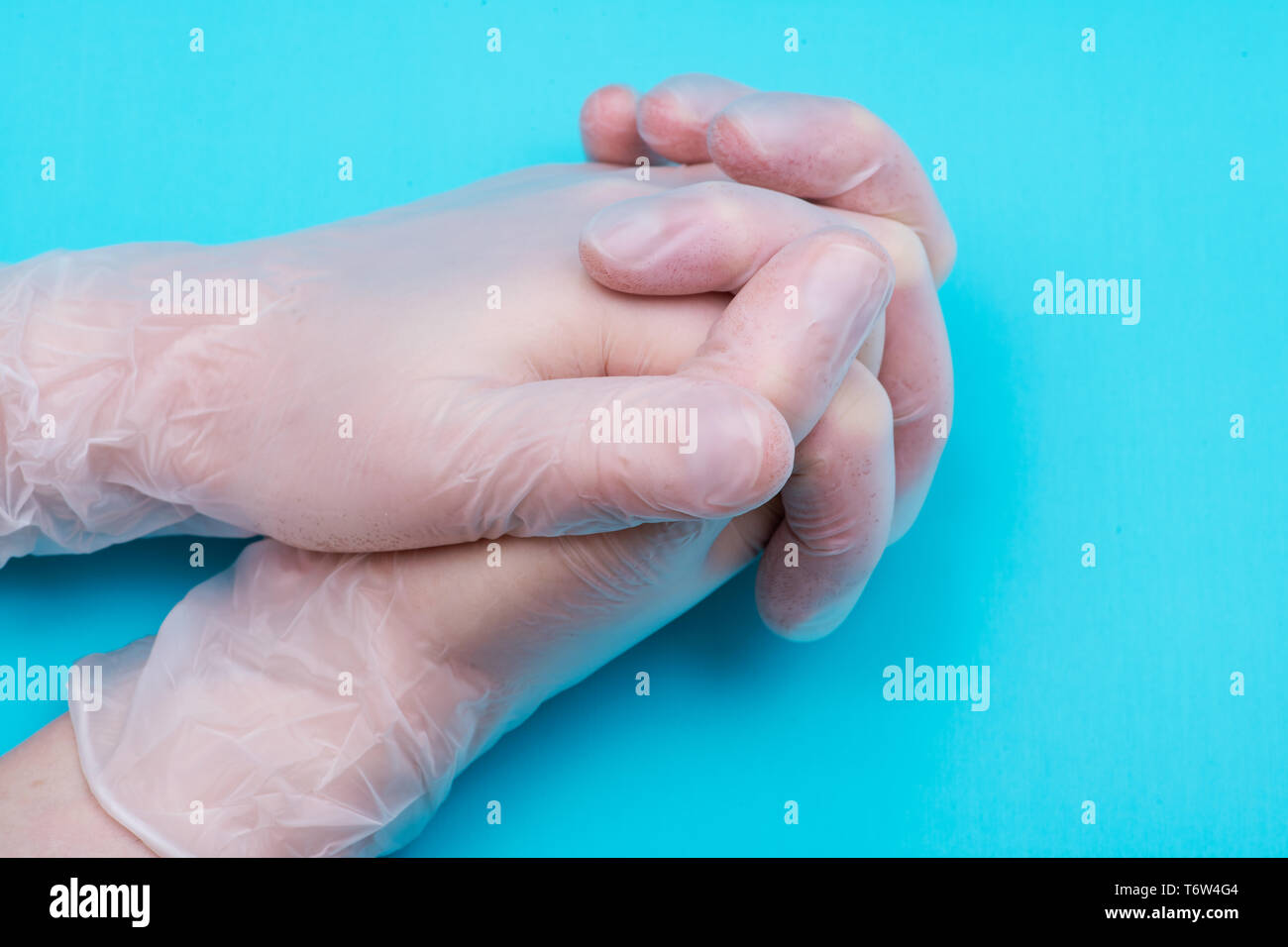 Medical Exam Quality Vinyl Gloves on colorful background. Stock Photo