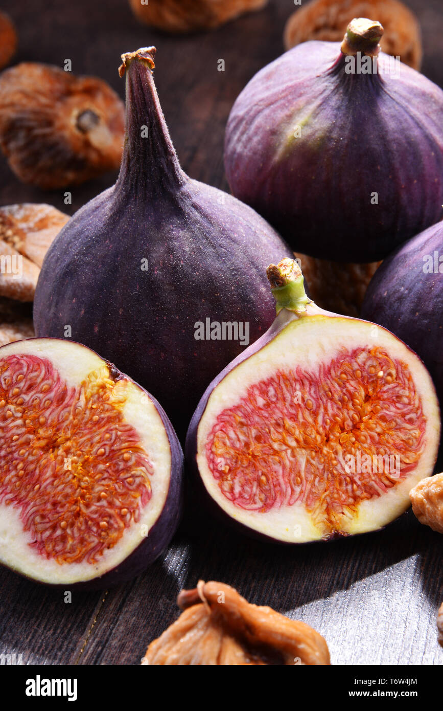 Composition with fresh and dried figs on wooden table Stock Photo - Alamy