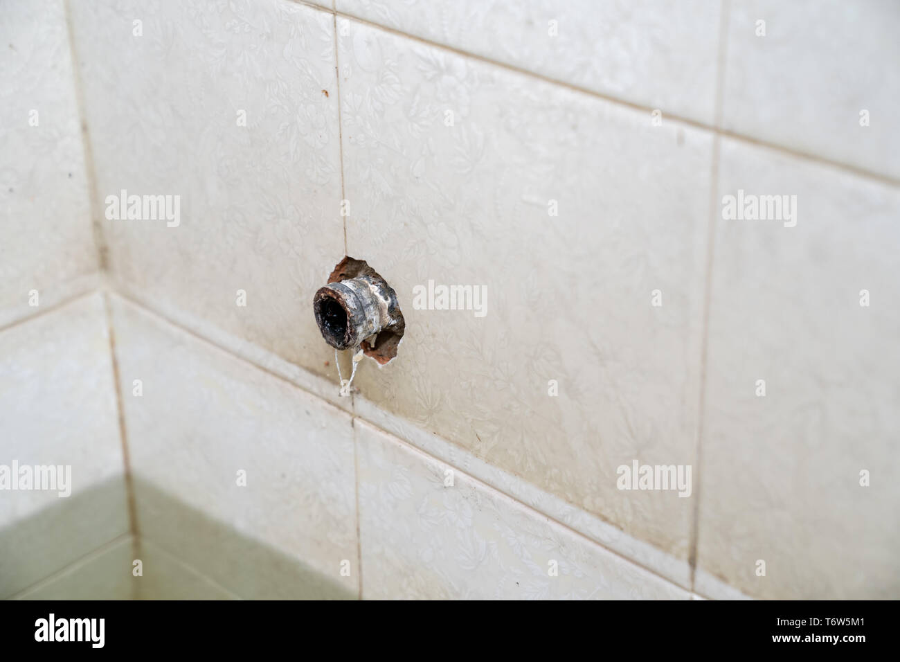broken pipe at the tile wall in the restroom Stock Photo Alamy