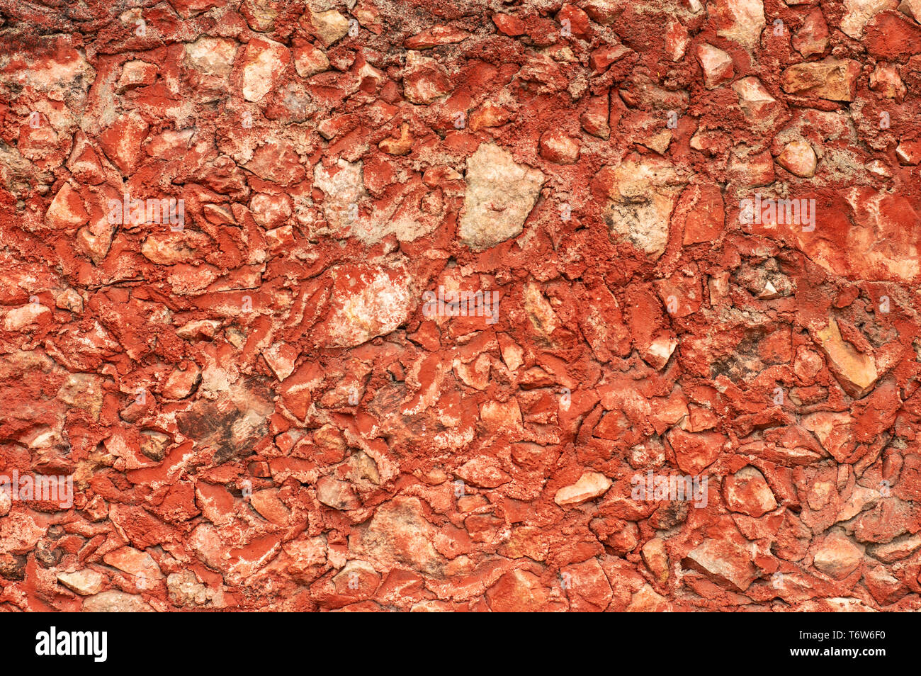Red Mexican stone wall texture from a hacienda in Yucatan Stock Photo