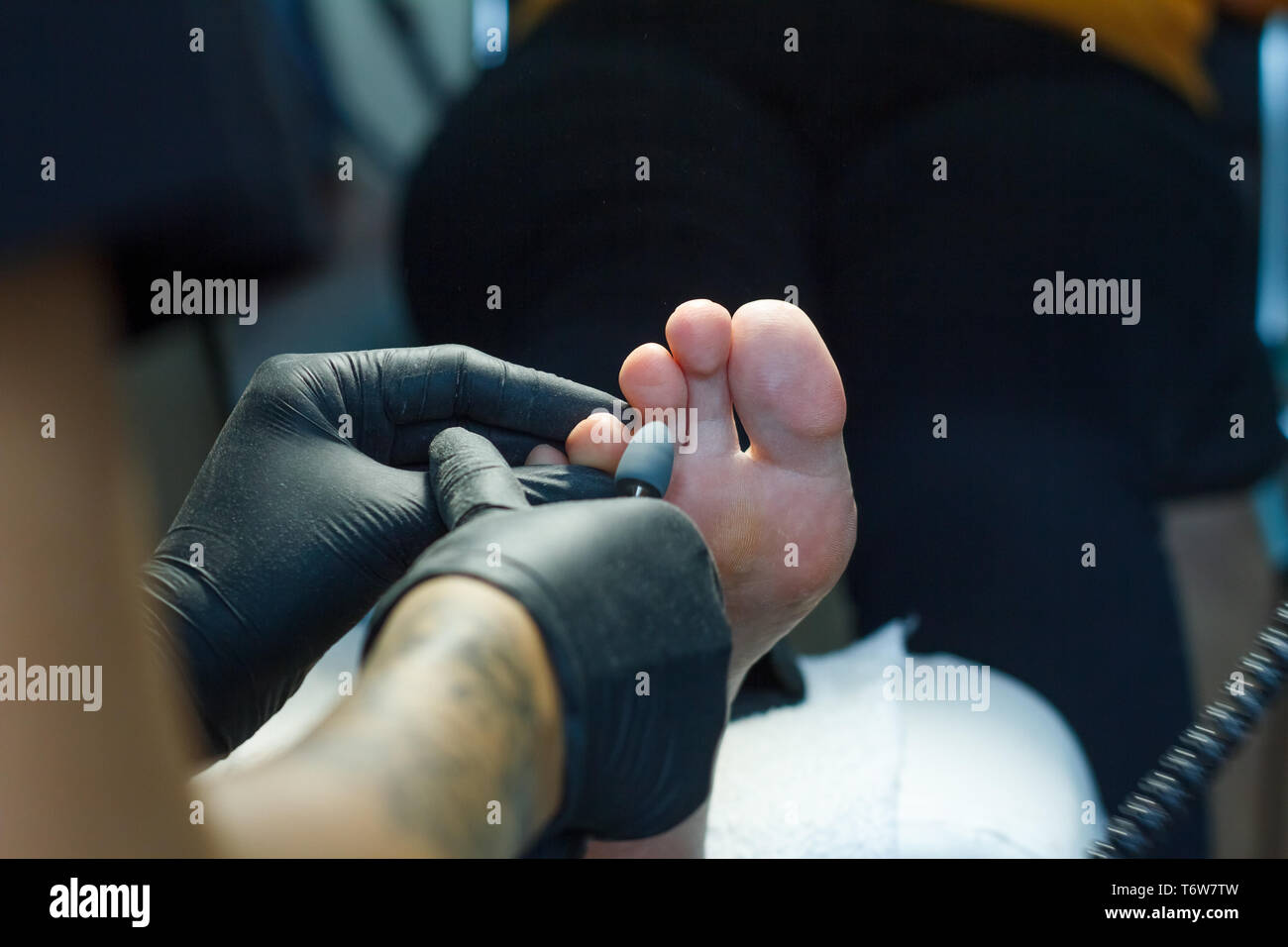 Professional hardware pedicure using electric machine.Patient on