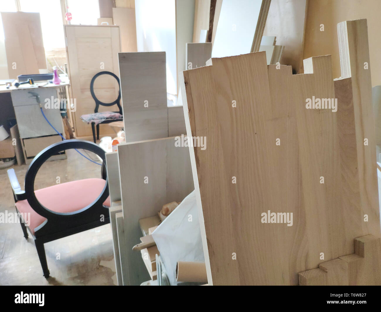 Manufacturing and repair of furniture. Workers make wooden chairs with