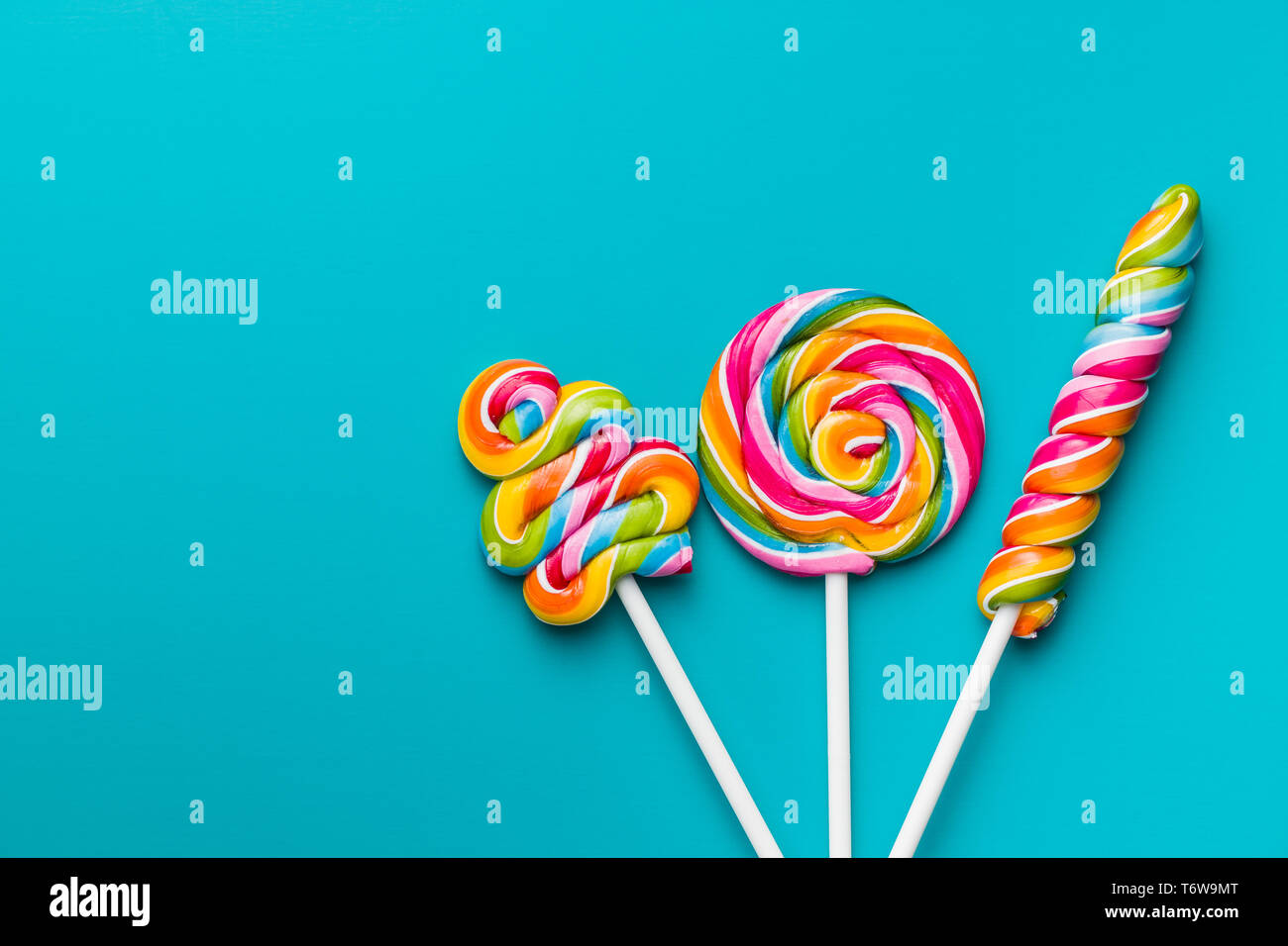 Various colorful lollipops on blue background. Stock Photo