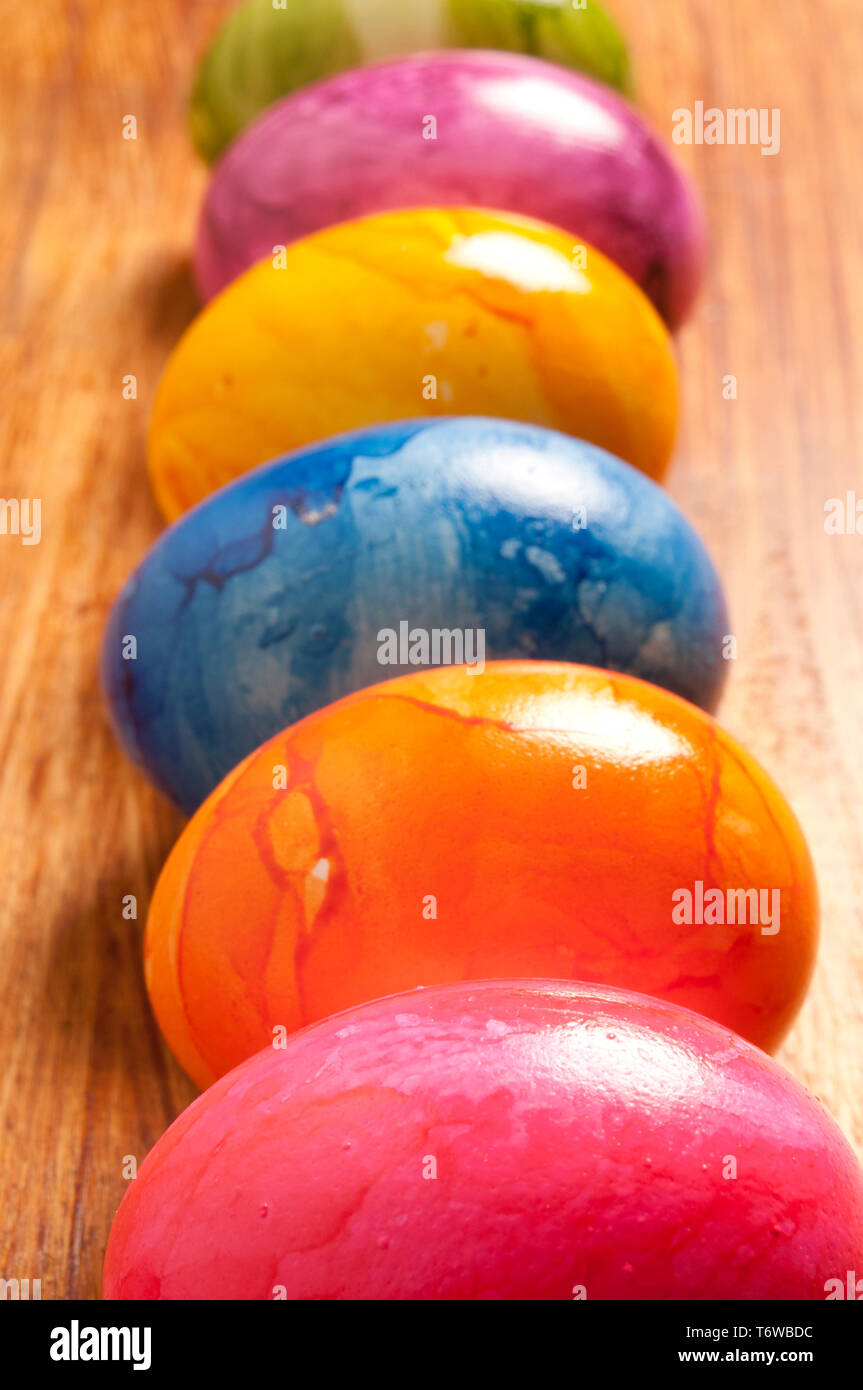 six colourful eggs in a row Stock Photo