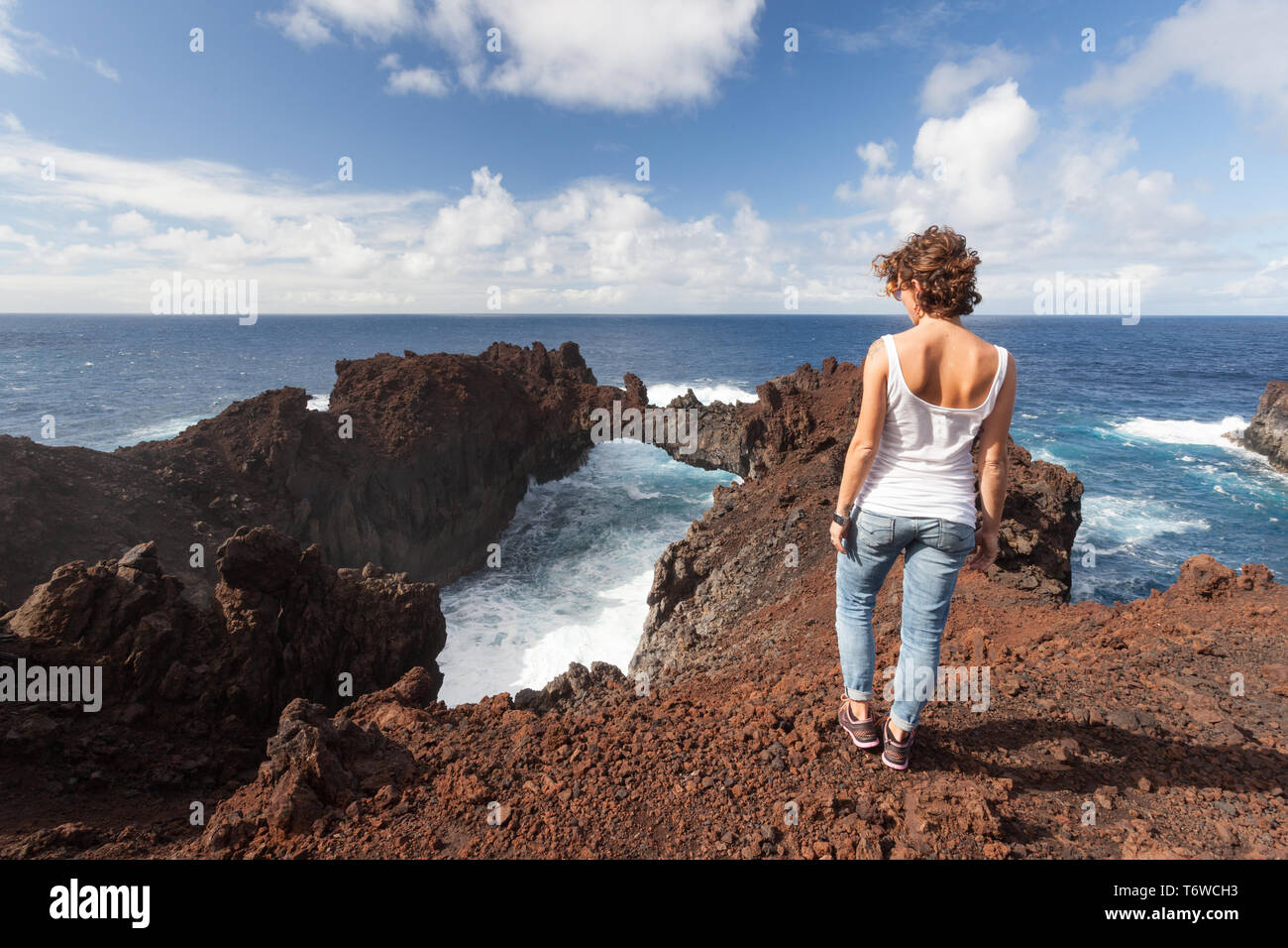 20 30 yrs old girl on top of a cliff over the atlantic ocean Stock Photo
