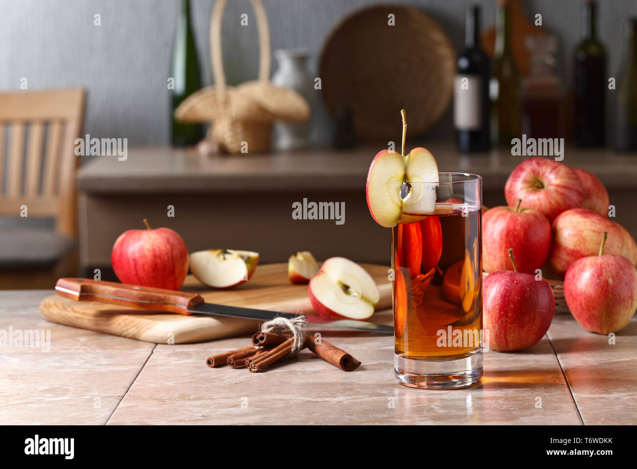 Glass of apple juice and ripe apples on a kitchen table Stock Photo - Alamy