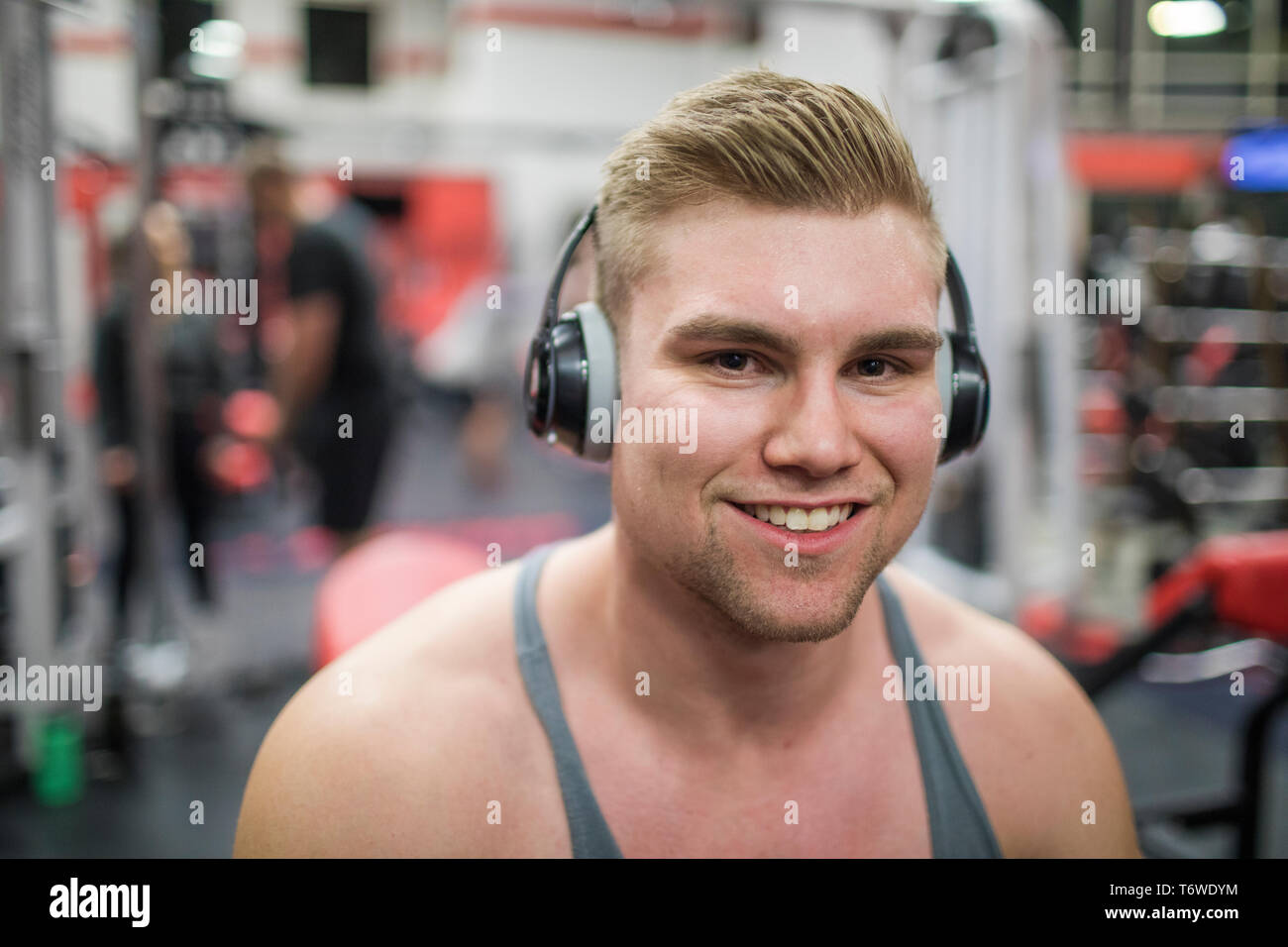 Portrait of bodybuilder wearing headphones at the gym Stock Photo
