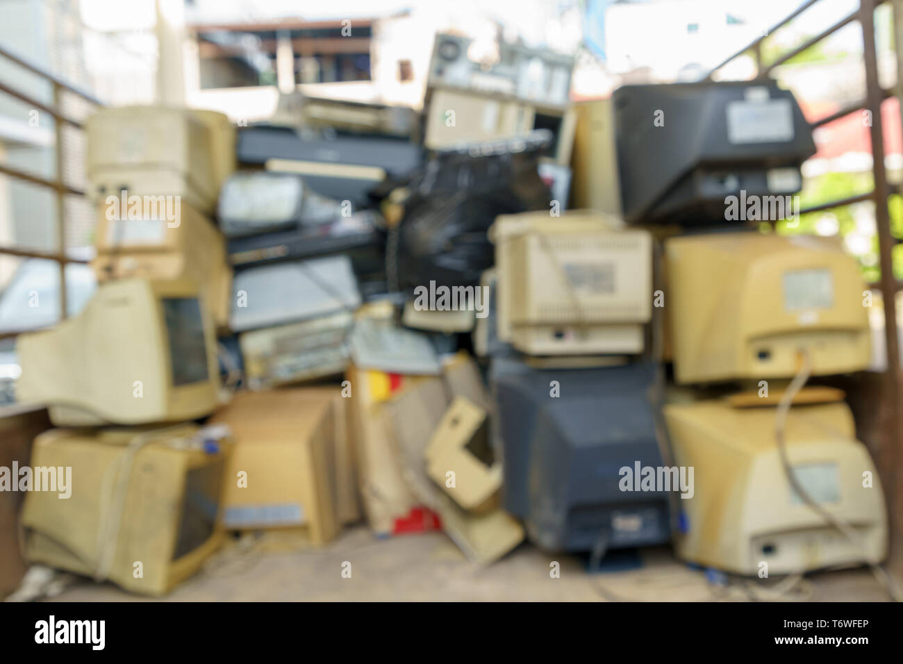 Abstract blur electronic waste stack together Monitor, Printer, desktop computer, fax for waiting to be recycled. Produced from plastic, copper, glass Stock Photo
