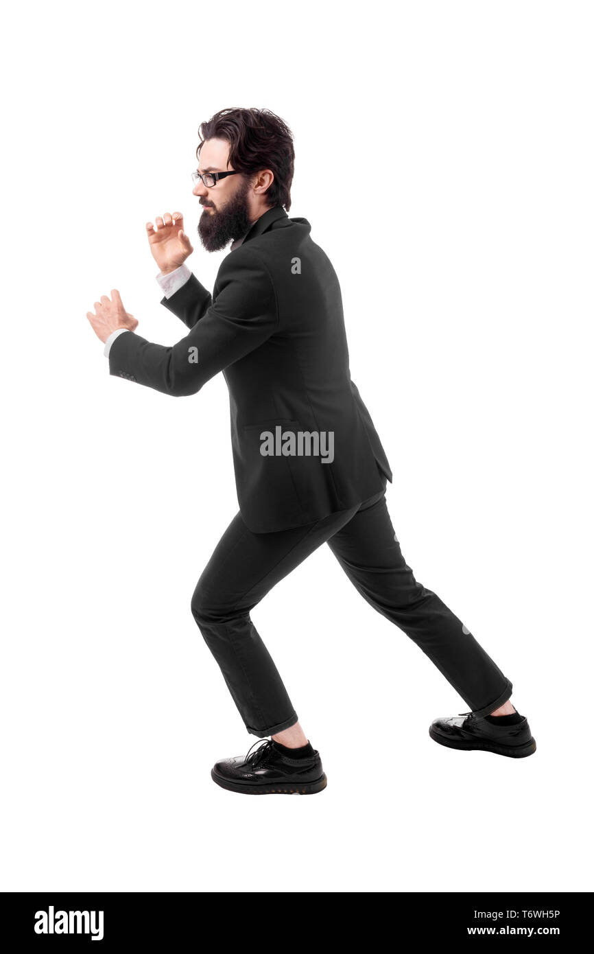 Full length portrait of a bearded businessman pulls an invisible rope ...