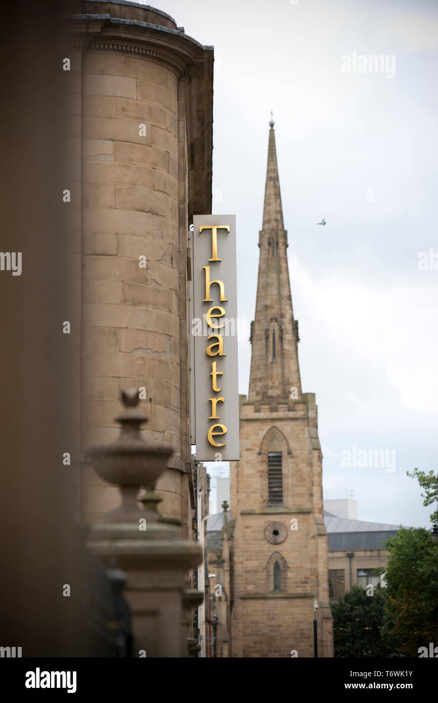 Huddersfield, West Yorkshire, UK, October 2013, a view of the sign for the lawrence batley theatre with St Paul's Concert Hall spire Stock Photo