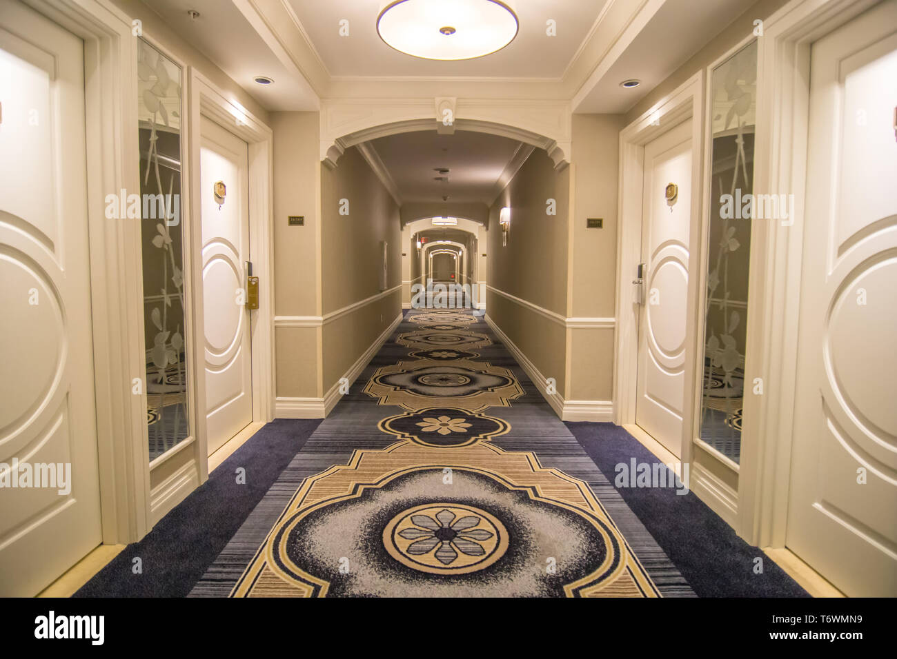 luxury hotel hall corridor well lit Stock Photo