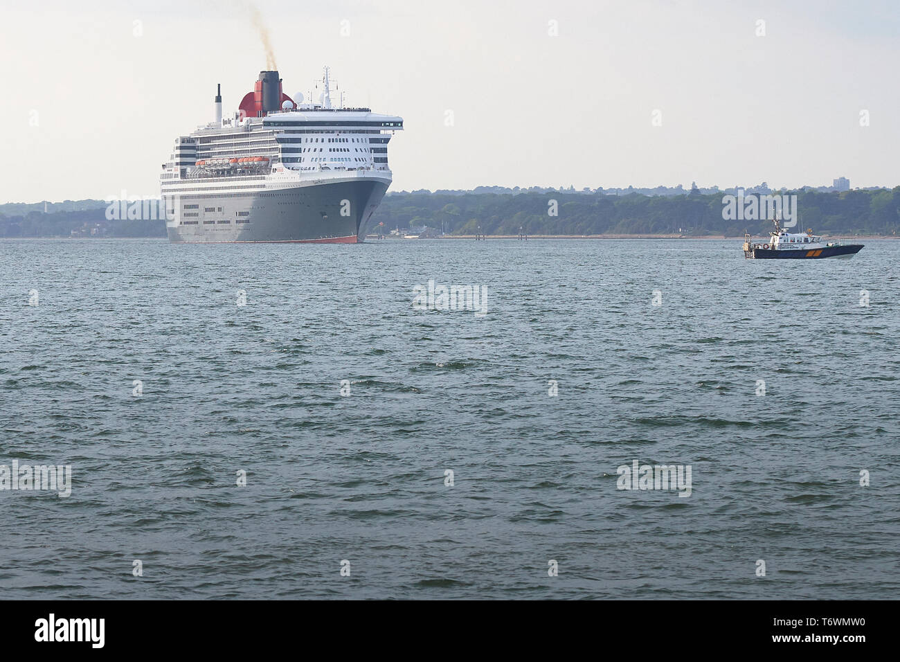 The Cunard Line Flagship, RMS QUEEN MARY 2, Steaming Out Of Southampton Water, UK. Bound For New York, 28 April 2019. Stock Photo