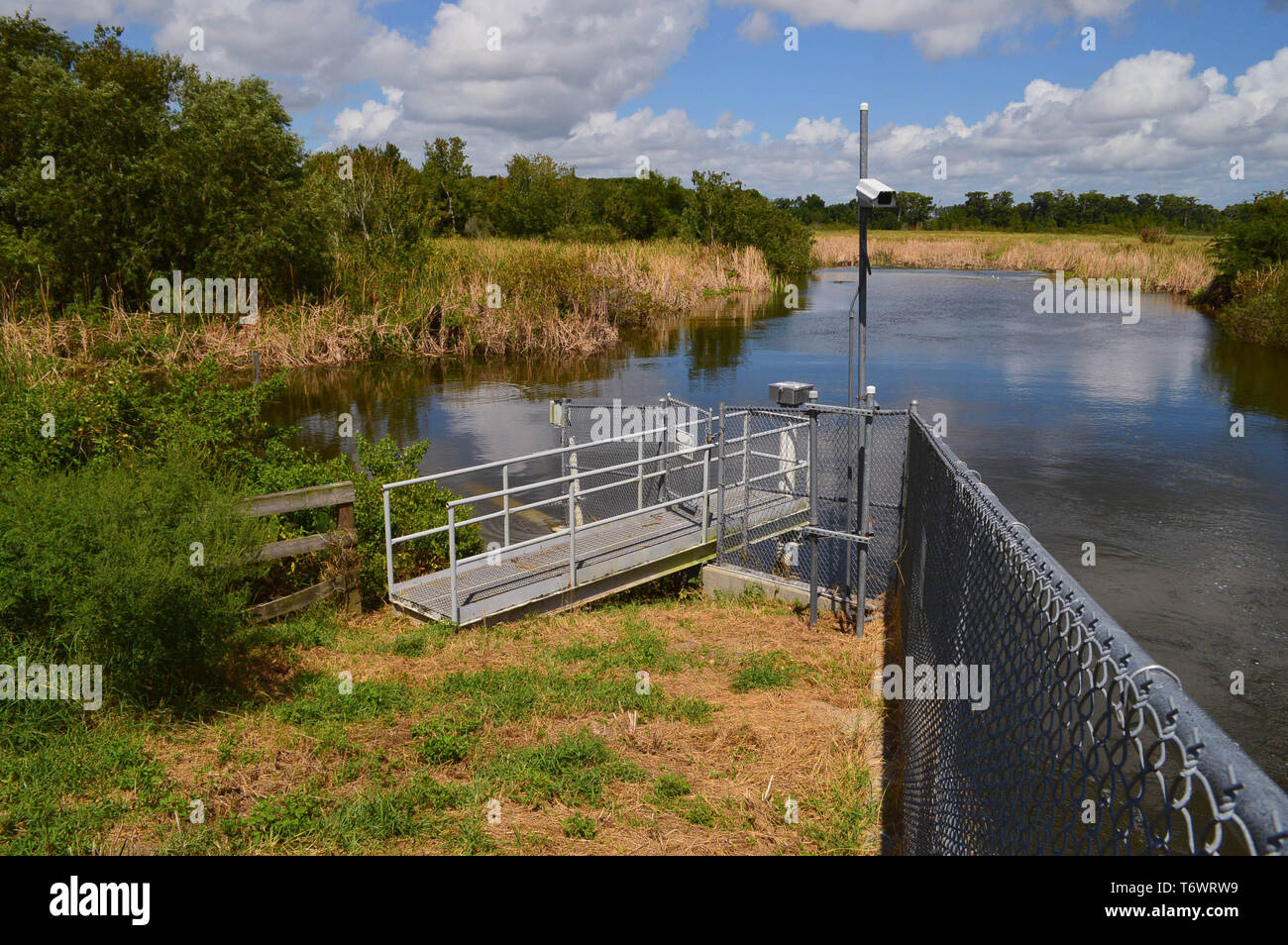 Secure Remote Location Observation Telemetry Fresh Water Lake Level Monitoring Equipment Station Gated Aluminum Walkway Chain Length Fence Florida Stock Photo