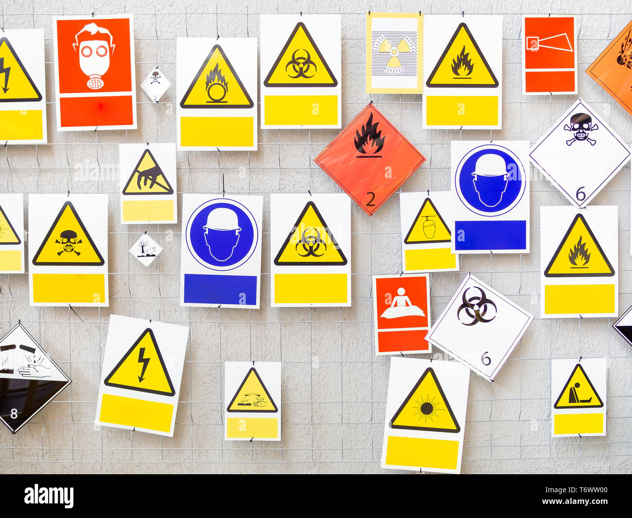 Many different danger signs on a wall, copy space Stock Photo