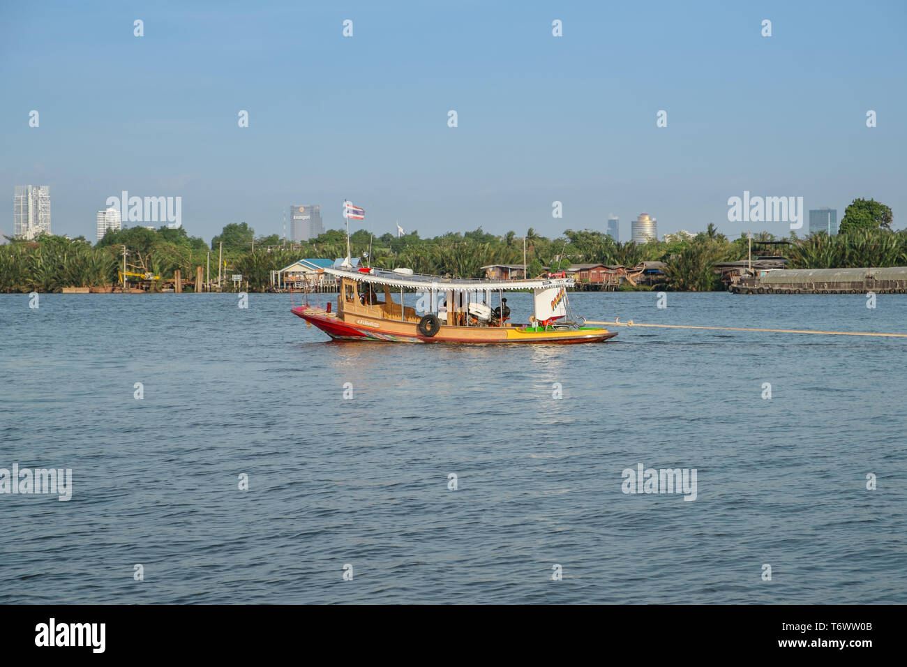 Samut Prakan,Thailand. April 27, 2019 : A local boat with Thai flag in Chao Phraya river. Bang Krachao. Stock Photo