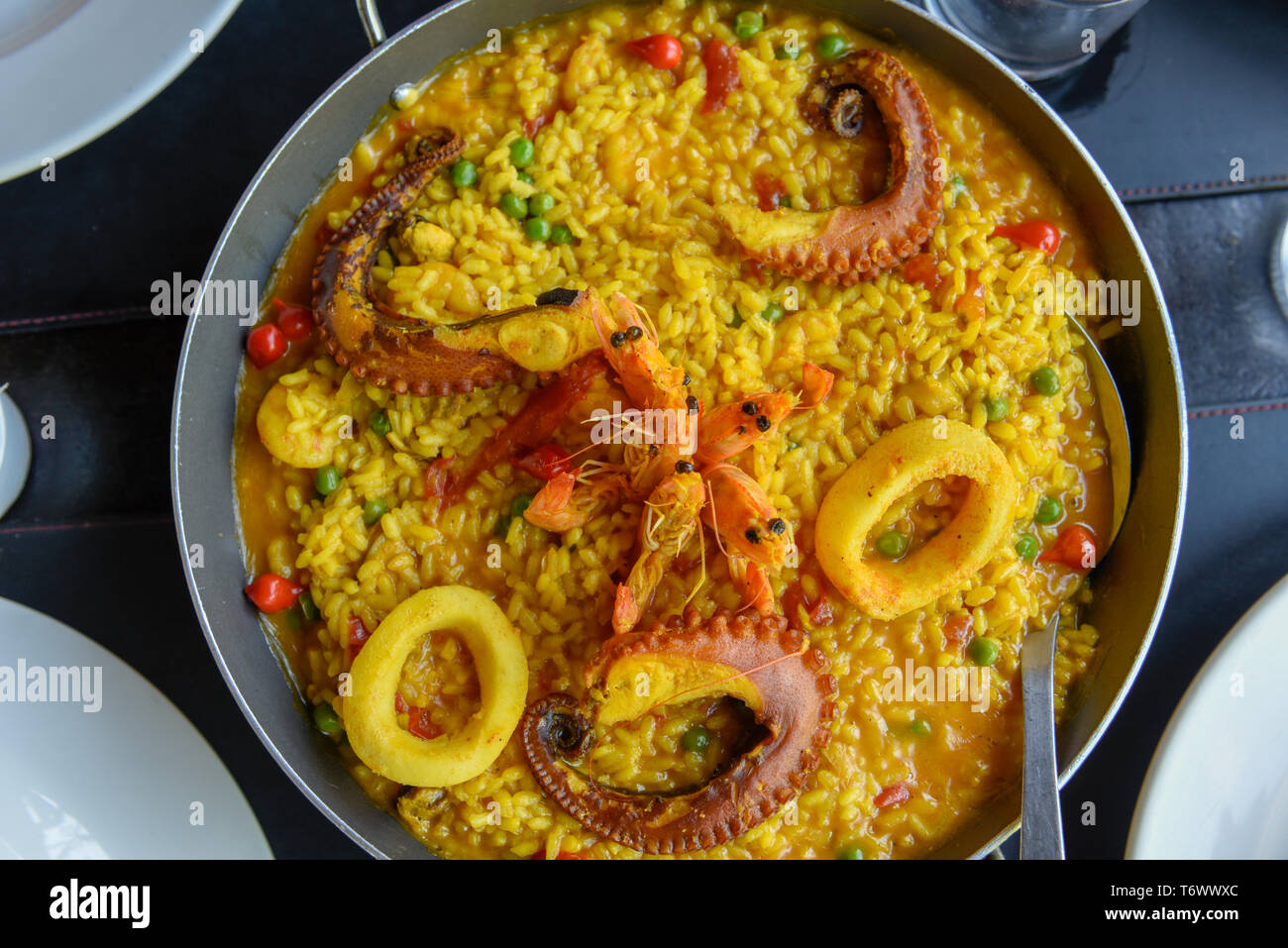 Gourmet seafood paella with fresh langoustine, clams, squid and octopus Stock Photo