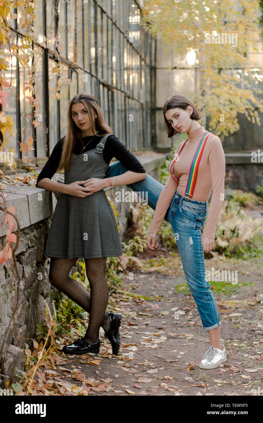 Two young fashion students in the autumn park Stock Photo