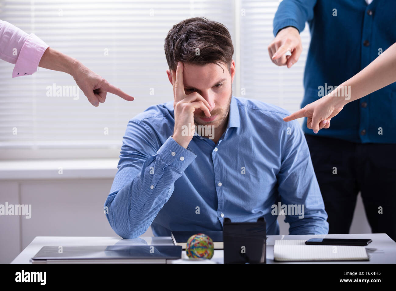 Many Hands Pointing The Stress Businessman At The Workplace Stock Photo