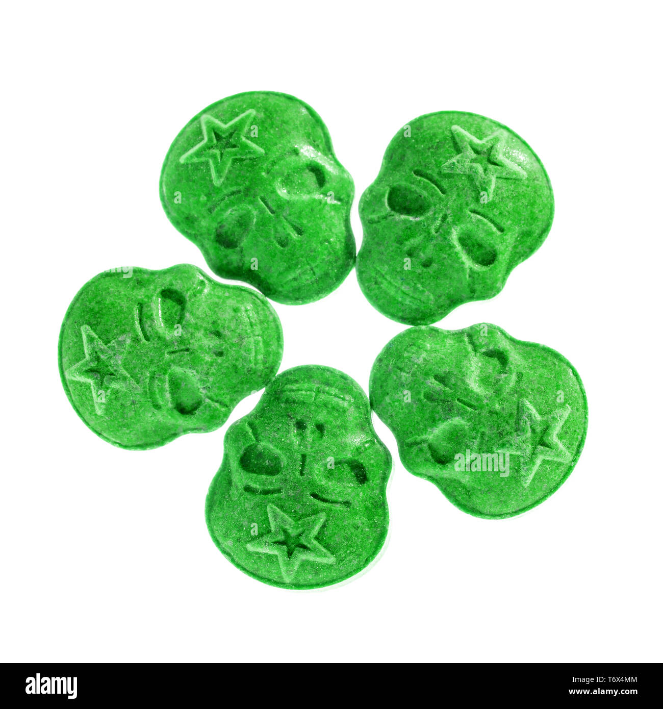 Five Green army Skull, Ecstasy, MDMA, Amphetamine or medication pills shaped like a skull isolated on a white background. Stock Photo