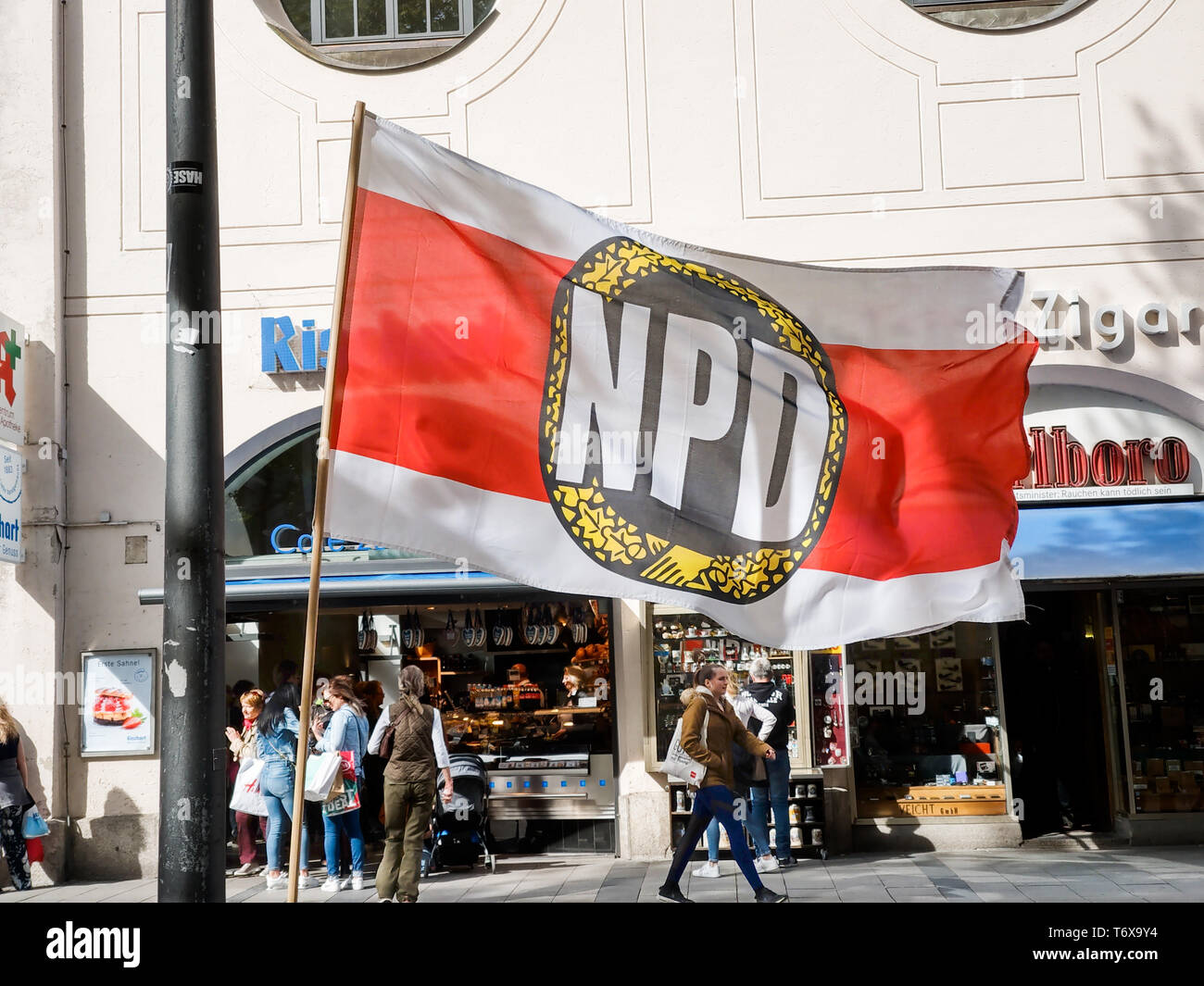 Munich, Bavaria, Germany. 2nd May, 2019. The neonazi NPD party organized an information table in one of the most-traveled districts of Munich- the pedestrian zone in the city center where shoppers, tourists and workers cross. Behind the table was Munich city councilman Karl Richter, part of the neonazi group Buergerinitiativ Auslaender Stopp (Citizen Initiative to Stopp Foreigners) and Renate Werlberger of the NPD. Both parties are widely accepted as being one and the same and confirmed by Richter in terms of ideology and membership. The duo also displayed placards with ''Migration Kills'', Stock Photo